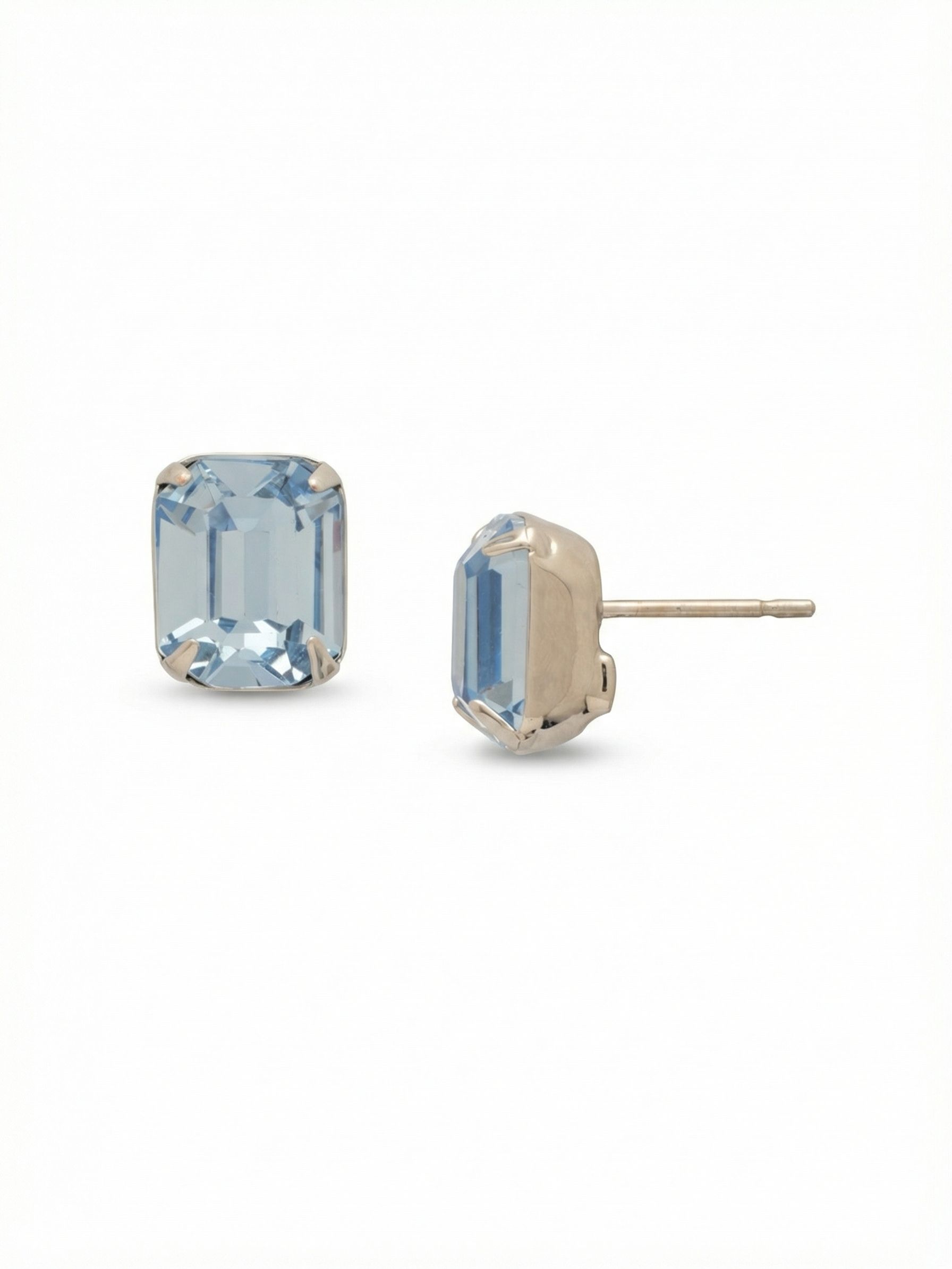 Octavia Stud Earrings - EDU53PDLTS - <p>A single emerald-cut crystal anchors this straightforward design. The pale blue stone offers clean architectural lines and steady light that reads beautifully across a table. Set in a cool metallic finish, the crisp geometry brings a quiet polish to your daily routine. Because a stone this size needs proper support, the included oversized comfort clutch keeps the piece perfectly balanced and secure from morning until night.</p><ul>
<li>Clean step-cut facets that draw light deep into the center</li>
<li>Architectural emerald-cut silhouette offering a minimal aesthetic</li>
<li>Post with oversized comfort-clutch back</li>
<li>Protective e-coat finish for lasting wear</li>
<li>Includes signature organza pouch for gifting and travel</li>
</ul>
