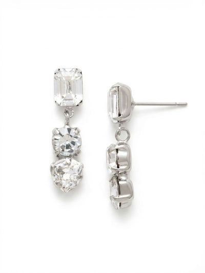 Florence Dangle Earrings - EEP13PDCRY - <p>Sharp geometry meets fluid movement in a linear drop earring. An emerald-cut post anchors the design, descending through a round crystal to finish with a crisp trillion cut. The single articulated joint allows the lower stones to swing naturally as you turn your head, catching the light across three distinct facet patterns. Despite the substantial visual presence, our oversized pressure-fit comfort back ensures the straight silhouette stays perfectly aligned and secure from morning to evening.</p><ul>
<li>Three distinct geometric crystal shapes layered in a linear silhouette</li>
<li>Articulated drop joint allows natural light-catching movement</li>
<li>Post with oversized comfort-clutch back</li>
<li>Protective e-coat finish for lasting wear</li>
<li>Includes signature organza pouch for gifting and travel</li>
</ul>