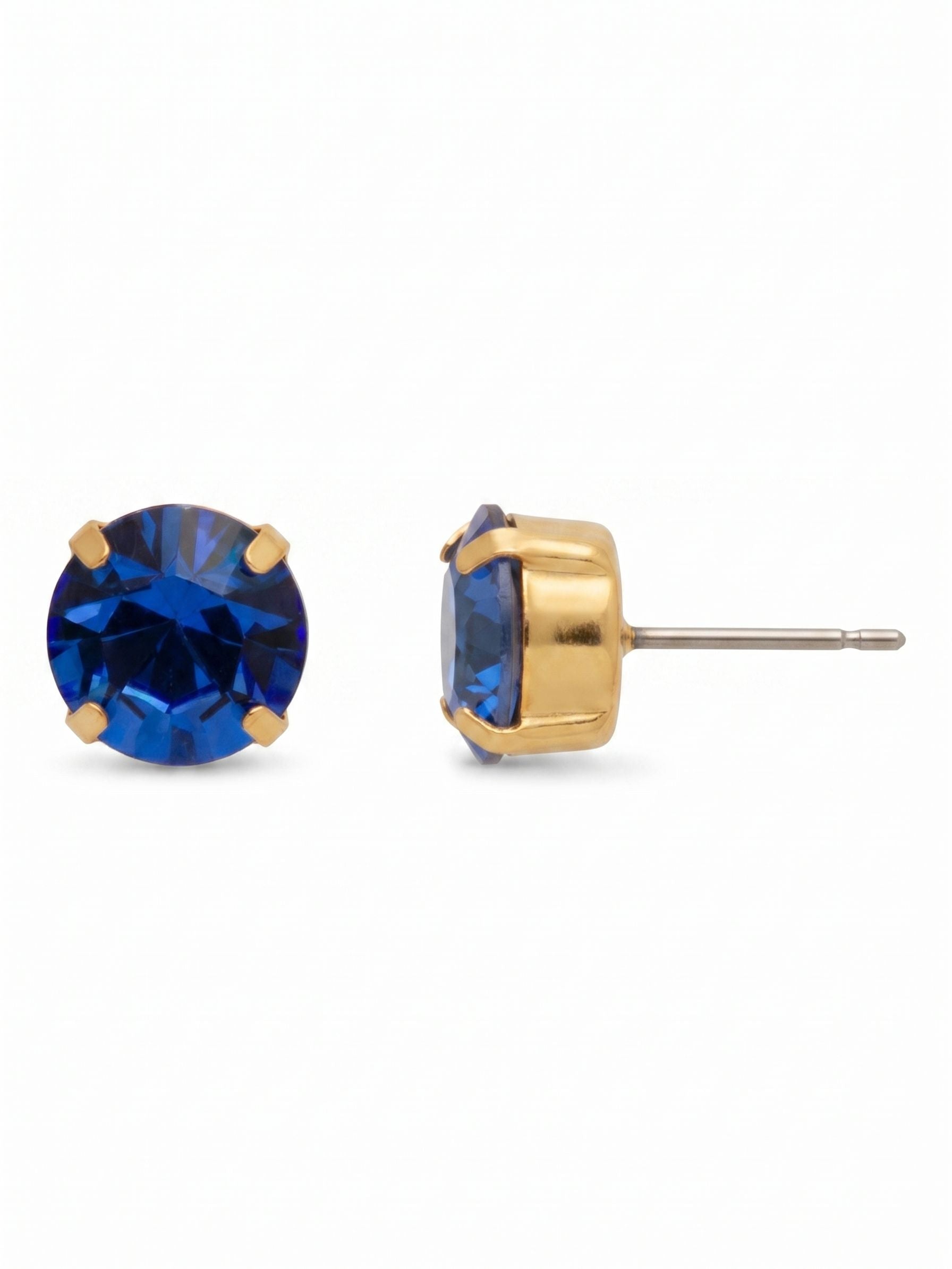 Simple Stud Earrings - EFC99BGSAP - <p>A deeply saturated sapphire blue crystal is held securely by four classic gold-tone prongs. Sized for everyday wear, this simple round-cut stud provides a crisp point of color that reads clearly even from across a table. The included oversized comfort clutch back keeps the post balanced and secure from morning meetings through dinner.</p><ul>
<li>Single round-cut crystal in a traditional four-prong setting</li>
<li>Deeply saturated blue color offers a sharp focal point</li>
<li>Post with oversized comfort-clutch back</li>
<li>Protective e-coat finish for lasting wear</li>
<li>Includes signature organza pouch for gifting and travel</li>
</ul>