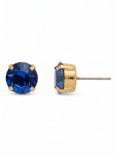 Simple Stud Earrings - EFC99BGSAP - <p>A deeply saturated sapphire blue crystal is held securely by four classic gold-tone prongs. Sized for everyday wear, this simple round-cut stud provides a crisp point of color that reads clearly even from across a table. The included oversized comfort clutch back keeps the post balanced and secure from morning meetings through dinner.</p><ul>
<li>Single round-cut crystal in a traditional four-prong setting</li>
<li>Deeply saturated blue color offers a sharp focal point</li>
<li>Post with oversized comfort-clutch back</li>
<li>Protective e-coat finish for lasting wear</li>
<li>Includes signature organza pouch for gifting and travel</li>
</ul>