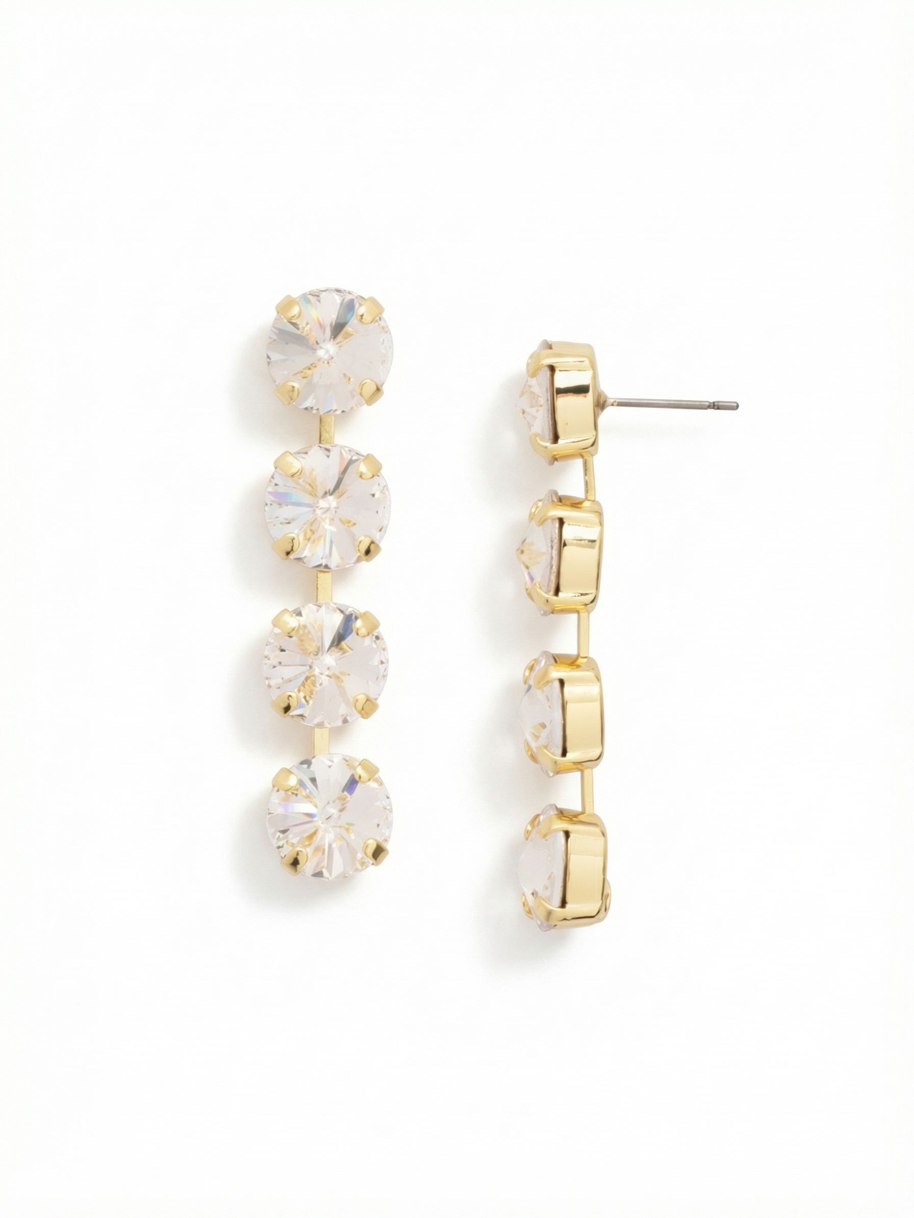 Mara Statement Earrings - EFD75BGCRY - <p>Four large round crystals descend in a clean, fluid line. The articulated construction allows the two-inch drop to sway gently with your movement, catching light from every angle. While these statement posts carry substantial visual weight, the oversized comfort backs ensure they sit securely and comfortably all day without tipping forward. The bright gold-tone settings frame the clear stones, creating a classic contrast that feels simultaneously grounded and highly polished.</p><ul>
<li>Fluid linear drop with articulated links for natural movement</li>
<li>Oversized round-cut crystals in a clean vertical alignment</li>
<li>Post with oversized comfort-clutch back</li>
<li>Protective e-coat finish for lasting wear</li>
<li>Includes signature organza pouch for gifting and travel</li>
</ul>
