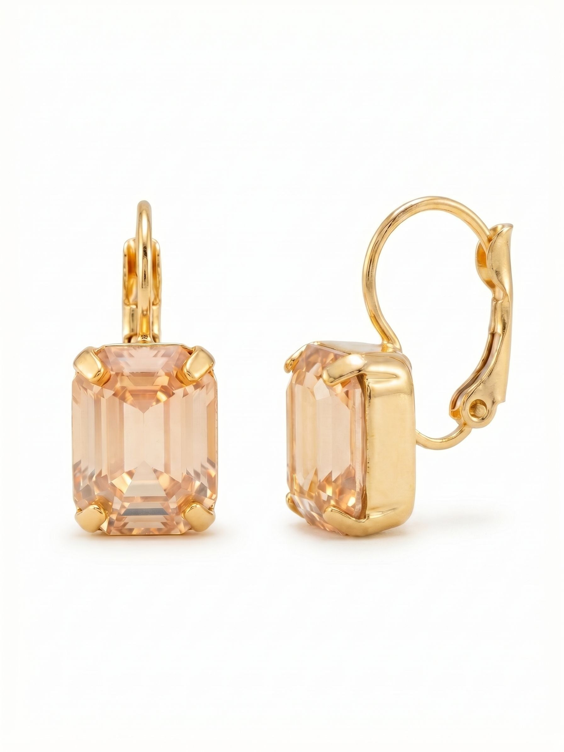 Octavia Dangle Earrings - EFK6BGGNS - <p>A single emerald-cut crystal acts as a shallow pool of warm light. The pairing of the golden shadow stone and the bright gold setting feels deliberate and highly polished. Step-cut facets flash quietly as you move, offering a structured, architectural kind of brilliance rather than scattered sparkle. Suspended securely, the compact drop keeps the stone close to the face, catching the light naturally throughout your day without heavy weight or distraction.</p><ul>
<li>Clean emerald-cut profile with structured step facets</li>
<li>Compact drop design that keeps the stone close to the face</li>
<li>Hook drop for easy, lightweight wear</li>
<li>Protective e-coat finish for lasting wear</li>
<li>Includes signature organza pouch for gifting and travel</li>
</ul>