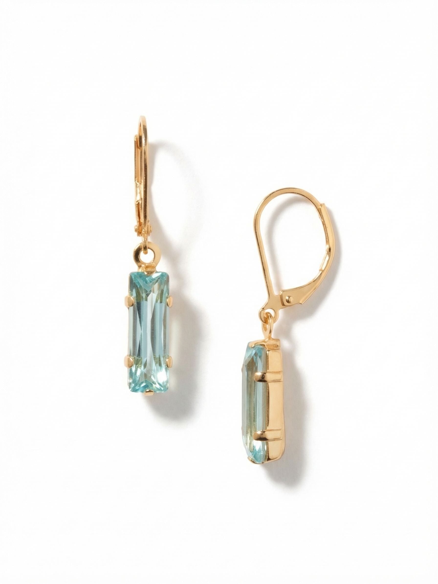 Bindi Dangle Earrings - EFP13BGAQU - <p>A single, elongated baguette crystal creates a clean line of light that sways just below the ear. The crisp aquamarine stone is held in a minimalist gold-tone setting, allowing its long facets to catch reflections with every movement. At just over an inch in length, this drop earring brings a subtle sense of length to your profile. The secure wire closure provides a comfortable fit that stays quietly in place throughout your day.</p><ul>
<li>Single elongated baguette crystal drop</li>
<li>Minimalist linear silhouette with step-cut facets</li>
<li>French wire drop for easy, lightweight wear</li>
<li>Protective e-coat finish for lasting wear</li>
<li>Includes signature organza pouch for gifting and travel</li>
</ul>