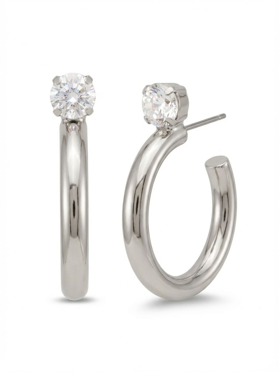 Keeley Studded Hoop Earrings - EFP26PDCRY - <p>A thick, polished curve of metal anchors to a single round-cut crystal resting directly at the piercing. This structural design bridges the gap between a classic solitaire stud and an open hoop. The nearly two-inch profile creates a strong visual presence, while the cool metallic shine catches light with every turn of the head. It offers a clean, architectural finish that transitions easily through your week, kept perfectly balanced and upright by an oversized comfort clutch.</p><ul>
<li>Thick tubular open hoop anchored by a single faceted round crystal</li>
<li>Clean architectural lines combining a classic stud with substantial drop length</li>
<li>Hoop earring</li>
<li>Protective e-coat finish for lasting wear</li>
<li>Includes signature organza pouch for gifting and travel</li>
</ul>