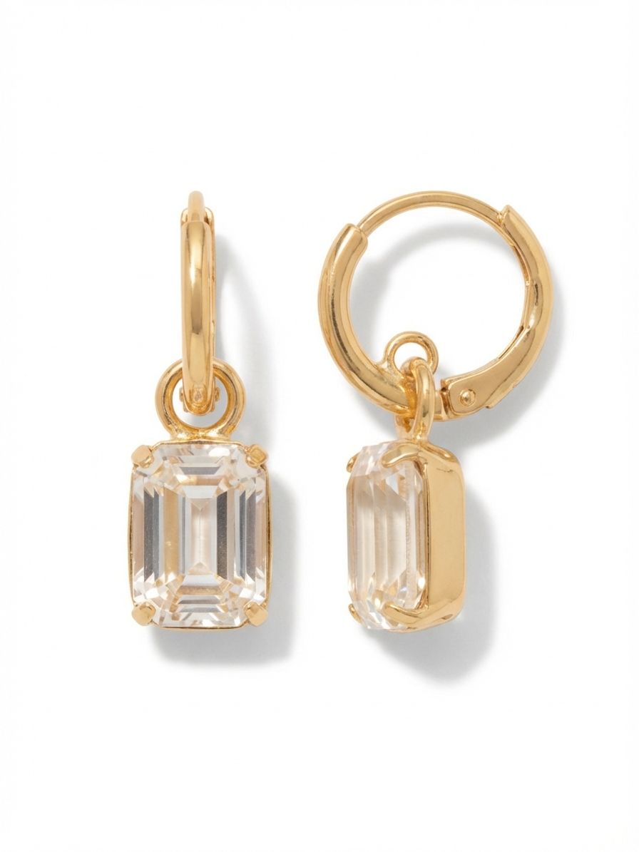 Octavia Huggie Hoop Earrings - EFS34BGCRY - <p>A structured take on the everyday drop earring. A single emerald-cut clear crystal hangs closely beneath a polished huggie, allowing the faceted stone to move independently and catch the light with subtle shifts in your posture. The clean, architectural lines of the cut provide a tailored contrast to the classic circular hoop. Designed to close securely and comfortably, these offer an effortless anchor for a stacked ear or a refined solo accent for the office.</p><ul>
<li>Clean architectural contrast between the circular hoop and rectangular crystal</li>
<li>Articulated drop design allows the stone to pivot and catch light</li>
<li>Huggie hoop with click-shut closure</li>
<li>Protective e-coat finish for lasting wear</li>
<li>Includes signature organza pouch for gifting and travel</li>
</ul>