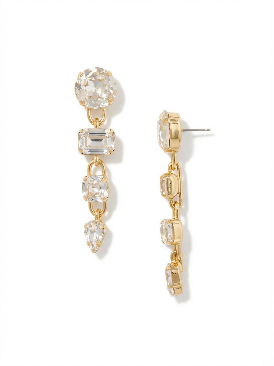 Kelly Statement Dangle Earrings - EFT1BGCRY - <p>Four distinct crystal cuts cascade down three full inches of articulated movement. A large round post anchors the design, dropping into emerald, square, and pear-cut clear crystals connected by paperclip chain links. This linear construction allows each stone to catch light independently as you walk. Because an earring of this scale requires proper support, the post includes an oversized comfort clutch to keep the weight balanced and secure from morning to night.</p><ul>
<li>Four distinct crystal shapes arranged in a descending linear sequence</li>
<li>Articulated paperclip chain links create independent swing for each stone</li>
<li>Post with oversized comfort-clutch back</li>
<li>Protective e-coat finish for lasting wear</li>
<li>Includes signature organza pouch for gifting and travel</li>
</ul>