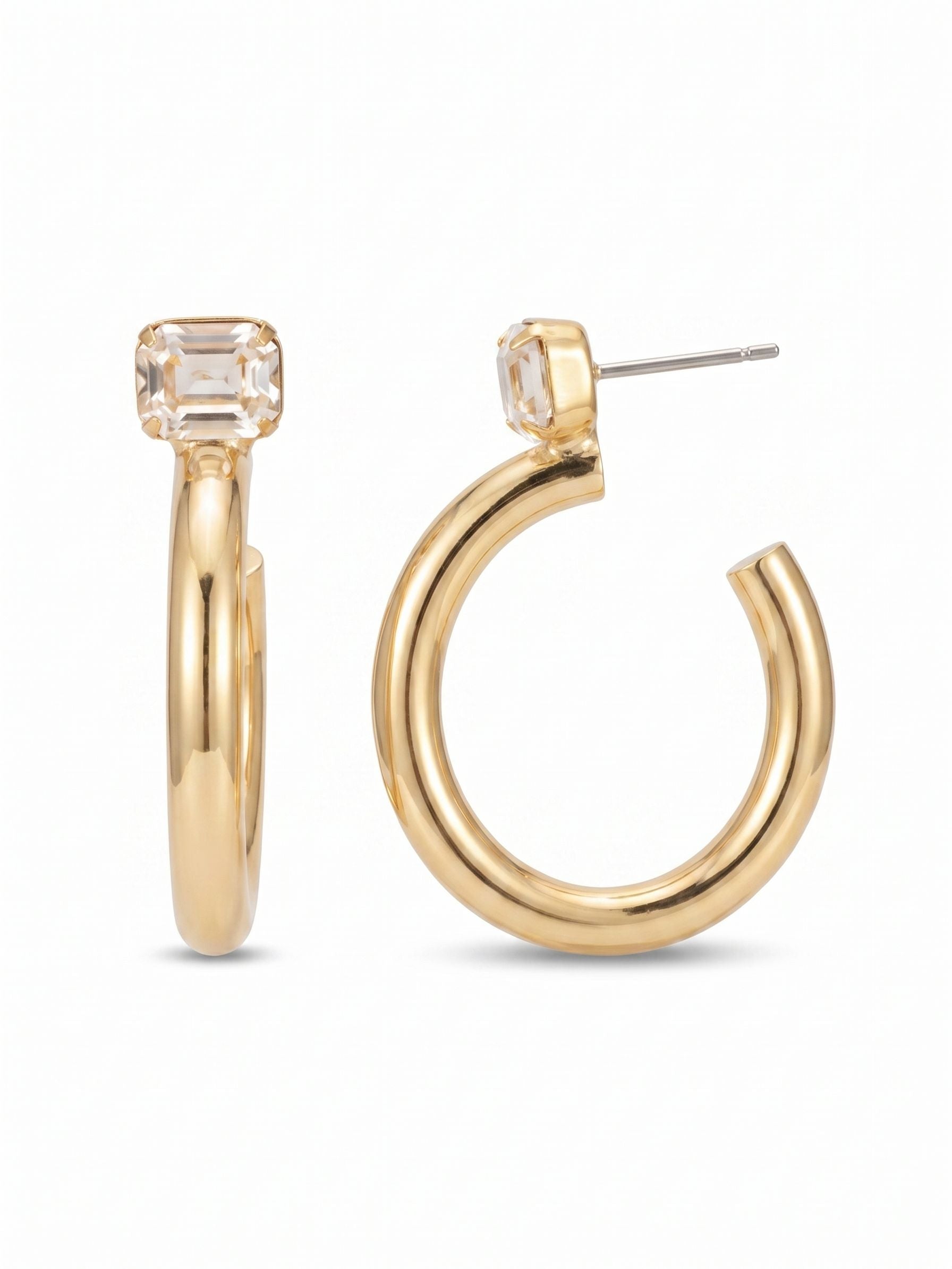Keeley Emerald Cut Hoop Earrings - EFU6BGCRY - <p>A modern reimagining of a jewelry box staple. The Keeley pairs the sleek geometry of a horizontally set emerald-cut crystal with the bold curve of a polished, open hoop. Worn like a stud, the thick metallic silhouette drops cleanly, catching light with every turn of the head. Because a substantial hoop needs proper support, we include an oversized comfort clutch to ensure the crystal sits perfectly flush all day without pulling. A quiet, confident update to your daily rotation.</p><ul>
<li>Horizontally set emerald-cut crystal anchors a thick polished open hoop</li>
<li>Front-facing profile blends architectural step cuts with smooth metallic curves</li>
<li>Hoop earring</li>
<li>Protective e-coat finish for lasting wear</li>
<li>Includes signature organza pouch for gifting and travel</li>
</ul>