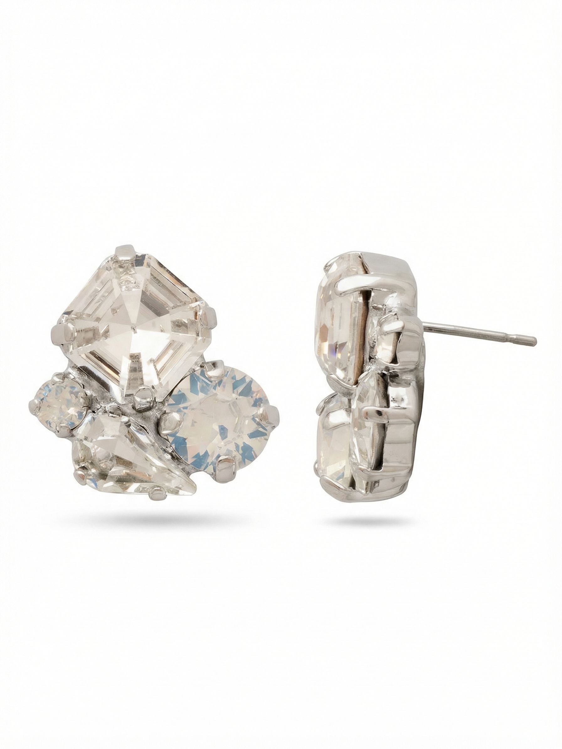 Anika Stud Earrings - EFY11PDCLA - <p>Sharp geometry meets milky opacity in an asymmetric cluster that commands attention. A cool square-cut crystal anchors the arrangement, balanced by the soft depth of round white opals and the clean lines of a pear-cut stone. At three-quarters of an inch, these substantial studs bring clear readable detail to your face. Because a larger post requires proper support, they come with an oversized pressure-fit back that holds the composition perfectly upright and comfortable throughout your day.</p><ul>
<li>Asymmetric cluster balancing sharp geometric crystals with milky opaque rounds</li>
<li>Substantial three-quarter inch scale that reads clearly from conversation distance</li>
<li>Post with oversized comfort-clutch back</li>
<li>Protective e-coat finish for lasting wear</li>
<li>Includes signature organza pouch for gifting and travel</li>
</ul>