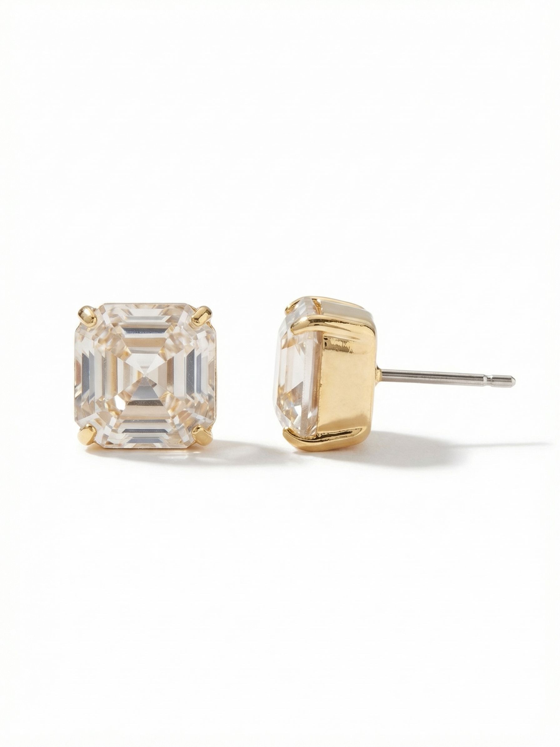 Izzy Stud Earrings - EFY1BGCRY - <p>A single, substantial square crystal rests closely against the ear, catching ambient light through its deep facets. The bright gold-tone prong setting frames the 10-millimeter stone with clean lines that read clearly at conversation distance. An oversized pressure-fit comfort back ensures this heavier stud remains balanced and secure throughout your day.</p><ul>
<li>Deeply faceted square crystal creating strong linear reflections</li>
<li>Substantial geometric scale that reads clearly across the room</li>
<li>Post with oversized comfort-clutch back</li>
<li>Protective e-coat finish for lasting wear</li>
<li>Includes signature organza pouch for gifting and travel</li>
</ul>