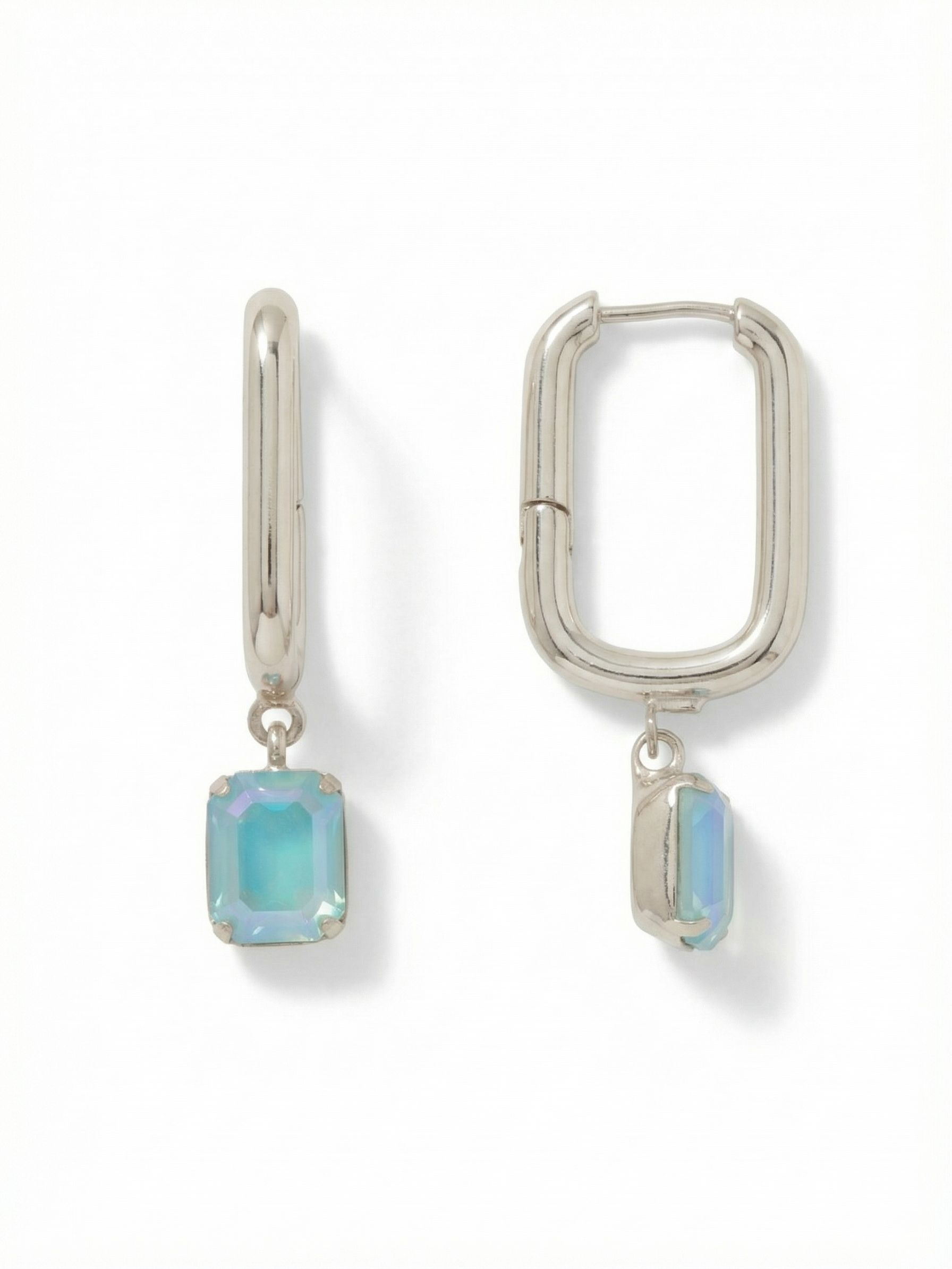 Octavia Rectangle Hoop Earrings - EFY7PDSBD - <p>The structured line of a rectangular hoop finds a softening counterbalance in a single suspended crystal. A faceted emerald-cut stone in watery blue catches the light with every movement of your head. The geometric shape of the polished metal mirrors the clean lines of the drop, creating a modern, cohesive silhouette. Designed with a hinged closure that clicks securely into place, these earrings offer a comfortable, lightweight presence that transitions effortlessly from morning meetings to evening dinners.</p><ul>
<li>Structured rectangular hoop mirrors the clean lines of the suspended crystal</li>
<li>Free-moving geometric stone creates continuous movement and light reflection</li>
<li>Hinged hoop with click-shut closure</li>
<li>Protective e-coat finish for lasting wear</li>
<li>Includes signature organza pouch for gifting and travel</li>
</ul>