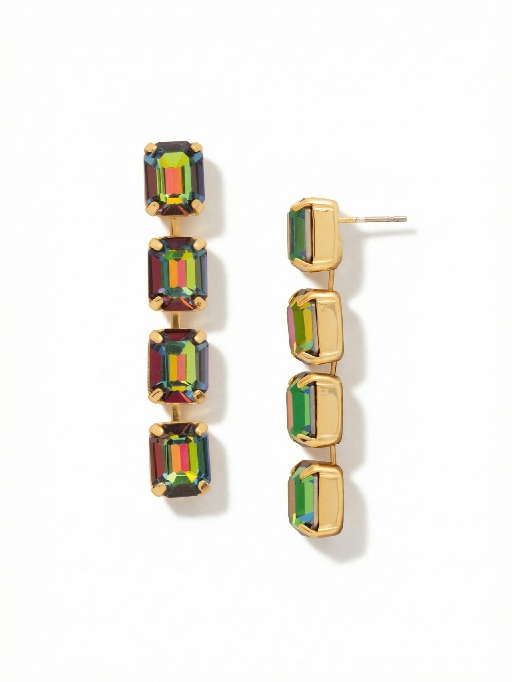 Octavia Repeating Dangle Earrings - EFZ6BGVO - <p>Four emerald-cut crystals form a clean, linear drop that shifts through deep greens, magentas, and rich ambers as you move. The articulated kette construction allows the earring to sway fluidly while maintaining its structured geometric shape. Measuring two inches in length, this pair offers substantial visual presence. An oversized comfort clutch keeps the top post sitting perfectly flush, ensuring the piece remains balanced and securely anchored from morning until evening.</p><ul>
<li>Repeating emerald-cut crystals create a clean geometric profile</li>
<li>Articulated channel construction allows for fluid vertical movement</li>
<li>Post with oversized comfort-clutch back</li>
<li>Protective e-coat finish for lasting wear</li>
<li>Includes signature organza pouch for gifting and travel</li>
</ul>