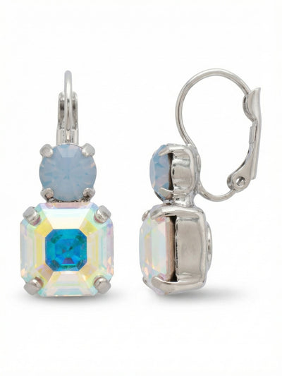 Kimber Dangle Earrings - EGB2PDRQ - <p>A soft, pale round of air blue opal rests above a sharply cut square of iridescent crystal. The cloudy blue tempers the bright, shifting flash of the aurora borealis below it, creating a balanced scale that catches light naturally as you move. Secured with a gentle hinged back, this one-inch drop remains light and comfortable through an entire afternoon while carrying enough visual weight to stand on its own.</p><ul>
<li>Contrasting pairing of soft opaque opal and bright iridescent crystal</li>
<li>Geometric vertical stack of distinct round and square cuts</li>
<li>Hook drop for easy, lightweight wear</li>
<li>Protective e-coat finish for lasting wear</li>
<li>Includes signature organza pouch for gifting and travel</li>
</ul>