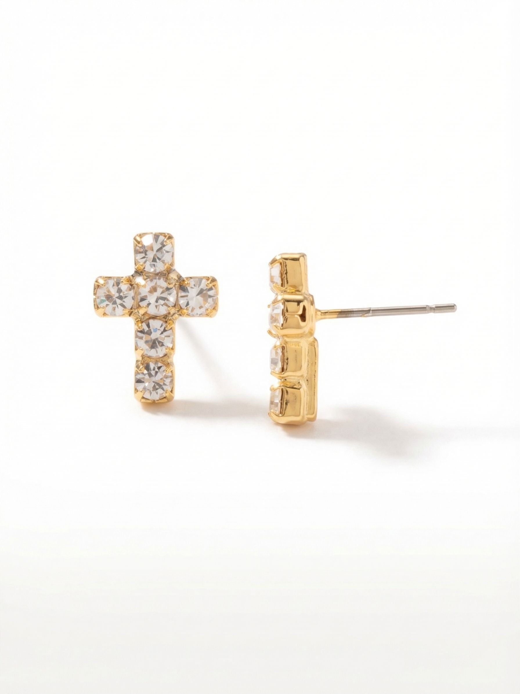 Carly Cross Stud Earrings - EGE88BGCRY - <p>A quiet motif rendered in clear, light-catching crystals. These petite cross studs arrange six round-cut stones into a neat half-inch design with an understated profile. The bright gold-tone setting gives the stones a warm glow, reading as a subtle flash of light from across the room. An oversized comfort clutch keeps the post balanced and secure all day. The scale feels natural for daily wear while the crystal setting brings a quiet polish to your routine.</p><ul>
<li>Petite cross silhouette formed by six closely set round crystals</li>
<li>Subtle scale designed to provide an understated catch of light</li>
<li>Post with oversized comfort-clutch back</li>
<li>Protective e-coat finish for lasting wear</li>
<li>Includes signature organza pouch for gifting and travel</li>
</ul>