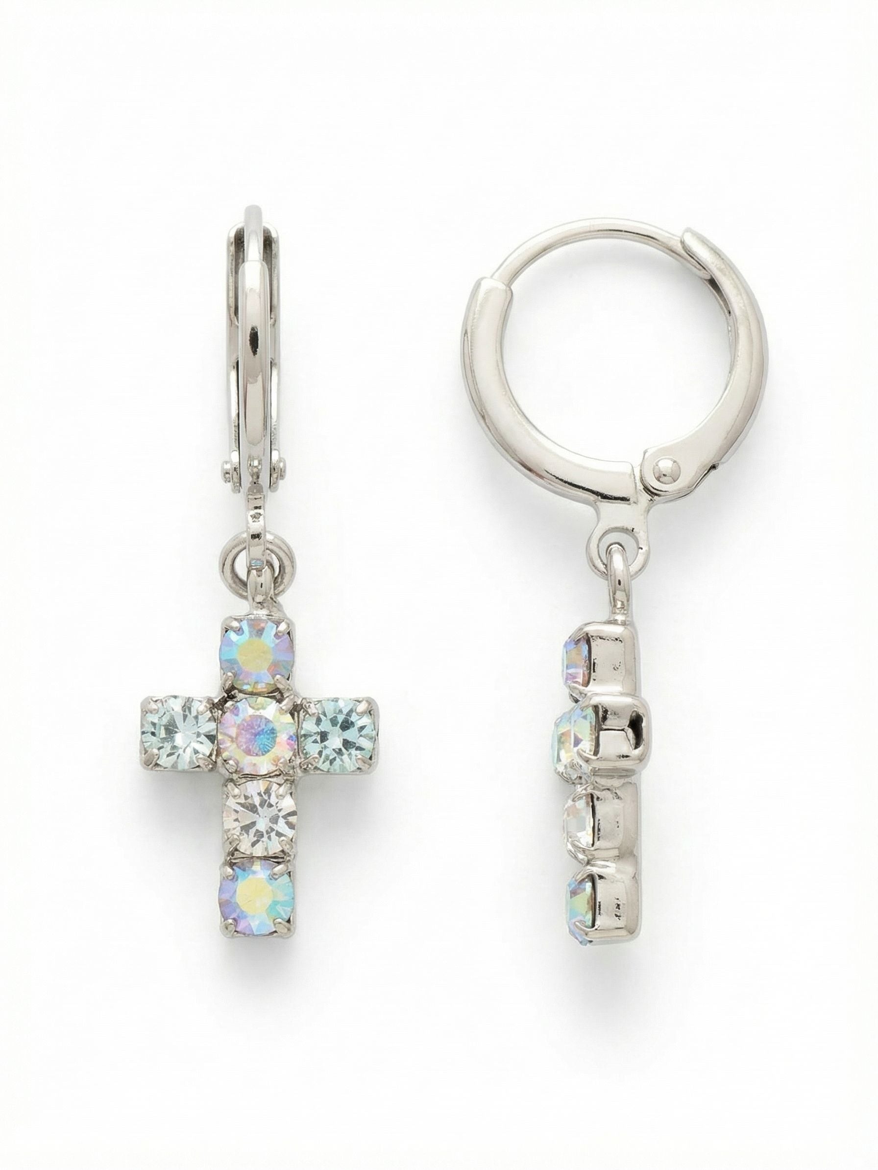 Carly Cross Huggie Hoop Earrings - EGE8PDRQ - <p>Balancing the security of a classic huggie with the gentle swing of a pendant, these drop earrings wear light and easy. The cross charm is constructed from round-cut crystals in soft, opalescent shades of pale blue and clear quartz that shift gently in the light. Suspended just below the ear, the one-and-a-half-inch profile offers quiet daytime presence without weighing you down, making it an effortless addition to your daily rotation.</p><ul>
<li>Soft pastel palette of opalescent and clear round-cut crystals</li>
<li>Subtle pendant movement suspended from a structured crystal cross</li>
<li>Huggie hoop with click-shut closure</li>
<li>Protective e-coat finish for lasting wear</li>
<li>Includes signature organza pouch for gifting and travel</li>
</ul>