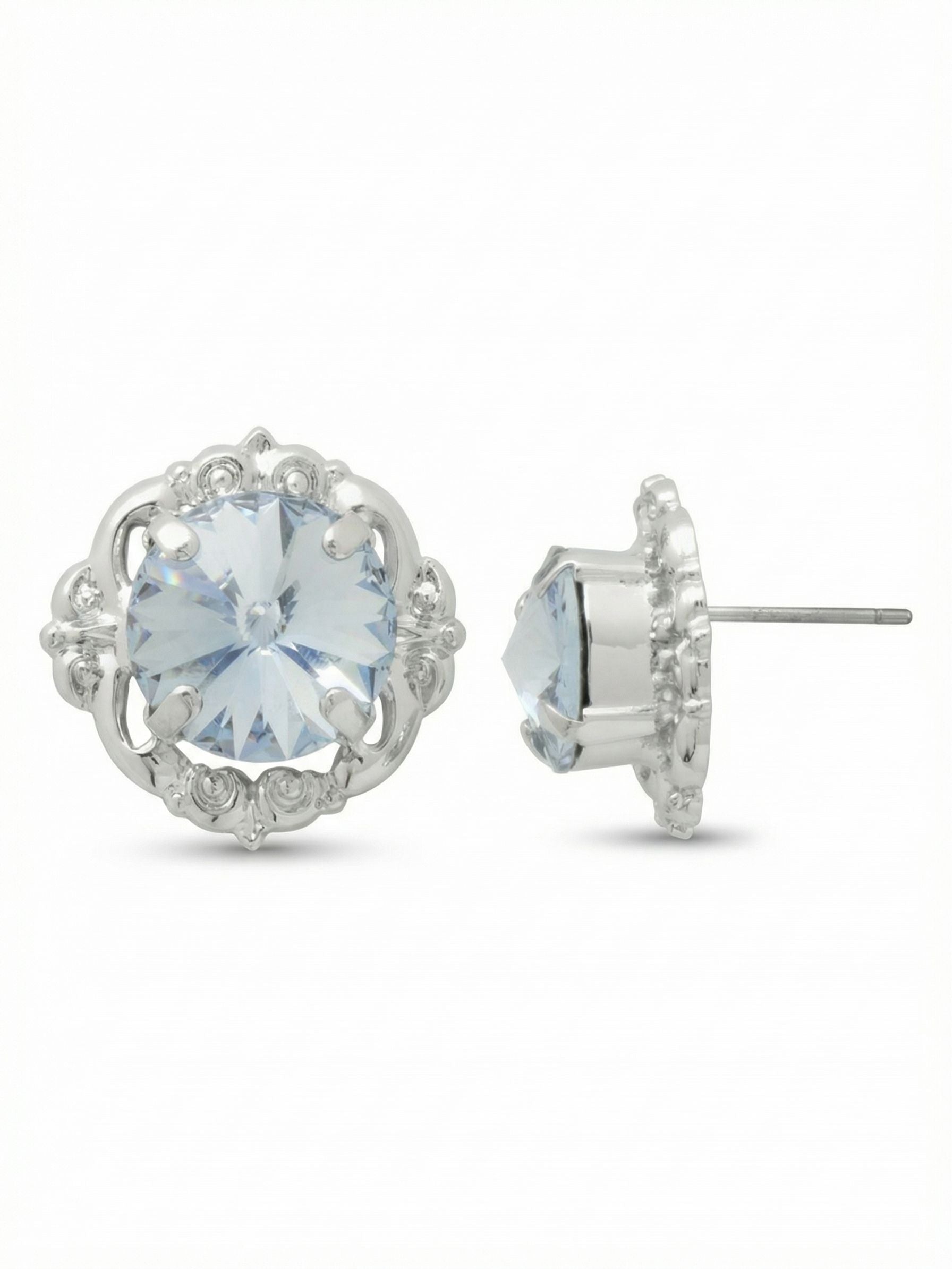 Lori Stud Earrings - EGI5PDLTS - <p>A substantial round crystal rests within a detailed metal frame to give these studs a defined presence. At half an inch wide, they read clearly across a table, catching and reflecting light through the pale blue center. The silver-toned setting adds a crisp brightness near the face. While they carry visual weight, an oversized comfort clutch keeps each earring secure and properly positioned from morning to night.</p><ul>
<li>Large central round stone anchored in a vintage-inspired scalloped frame</li>
<li>Open metal setting creates subtle dimension around the crystal</li>
<li>Post with oversized comfort-clutch back</li>
<li>Protective e-coat finish for lasting wear</li>
<li>Includes signature organza pouch for gifting and travel</li>
</ul>