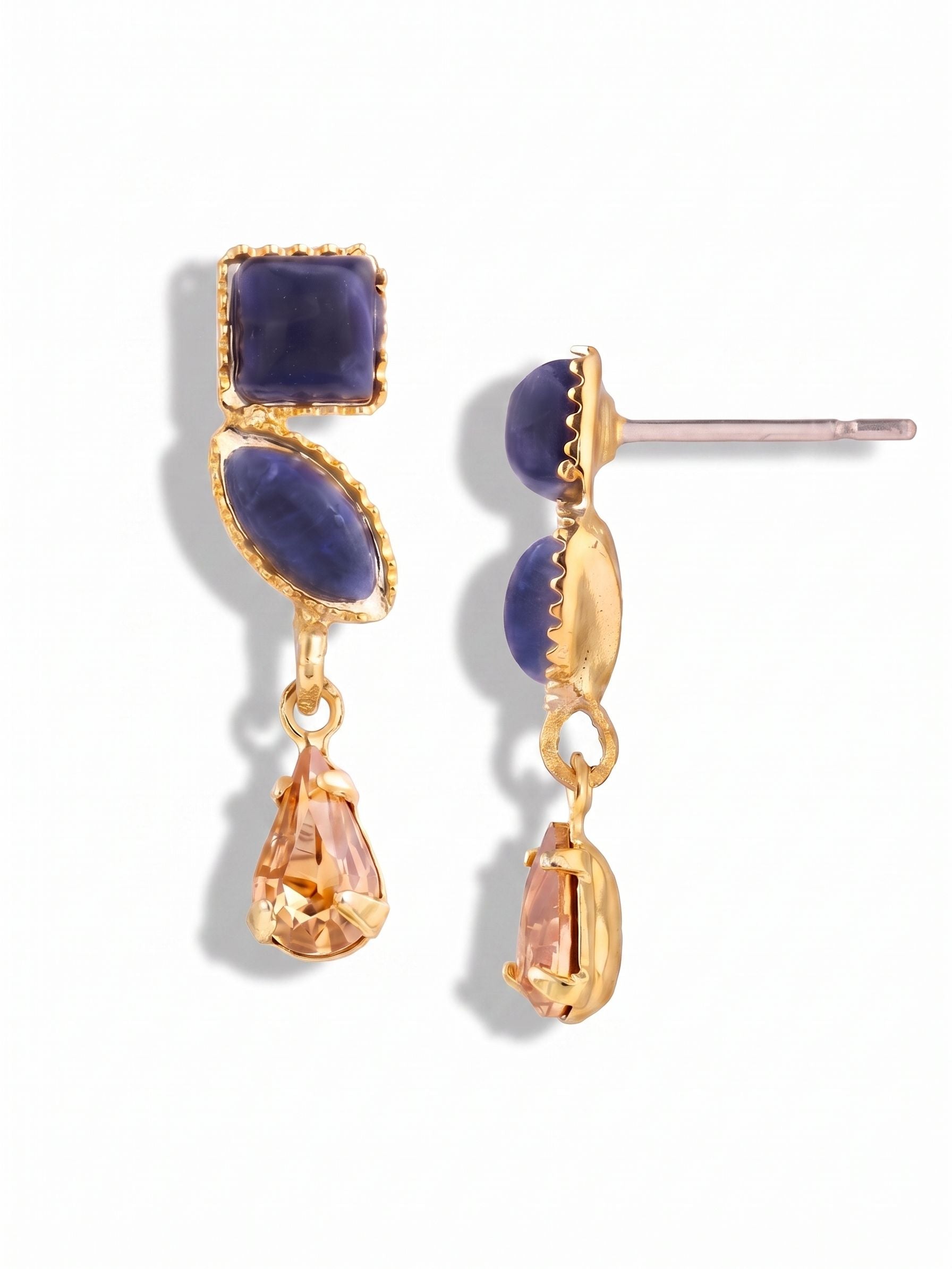Indie Dangle Earrings - EGI6BGDNM - <p>At three quarters of an inch, these earrings bring a subtle wash of color without overwhelming the face. Two deep blue opaque sodalite stones sit firmly against the ear, creating a quiet foundation for the warm, faceted pear drop suspended below. The small link allows the golden crystal to catch light gently as you move. Finished with our oversized clutch backing, the lightweight post design remains perfectly balanced and secure throughout a busy afternoon.</p><ul>
<li>Deep opaque sodalite contrasting with a single faceted light-catching crystal drop</li>
<li>A delicate three-stone descending silhouette with subtle kinetic movement</li>
<li>Post with oversized comfort-clutch back</li>
<li>Protective e-coat finish for lasting wear</li>
<li>Includes organza pouch for gifting and travel</li>
</ul>