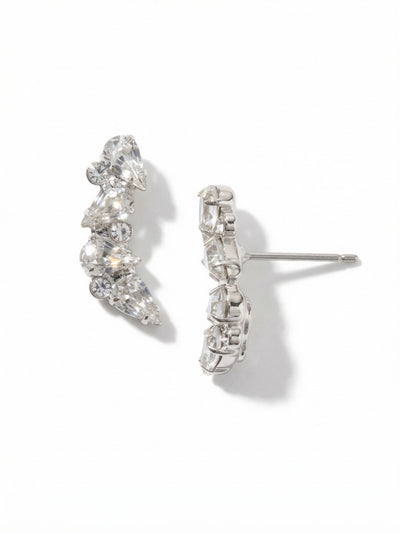 Eloise Stud Earrings - EGJ10PDCRY - <p>The Eloise Stud Earrings trace a subtle curve, designed to subtly follow the natural line of the ear. Pear-cut clear crystals catch the light from multiple angles, anchored by tiny round stones tucked into the bright palladium setting. At three-quarters of an inch long, they offer enough presence to be noticed across a table while remaining comfortable enough for morning-to-night wear. An oversized monster back clutch keeps each earring secure, ensuring the gracefully curved silhouette stays perfectly positioned all day.</p><ul>
<li>Gently curved profile designed to follow natural contours</li>
<li>Asymmetrical clustering of pear and round crystals creates a trailing light effect</li>
<li>Designed to wear as an ear climber or drop stud.</li>
<li>Post with oversized comfort-clutch back</li>
<li>Protective e-coat finish for lasting wear</li>
<li>Includes signature organza pouch for gifting and travel</li>
</ul>