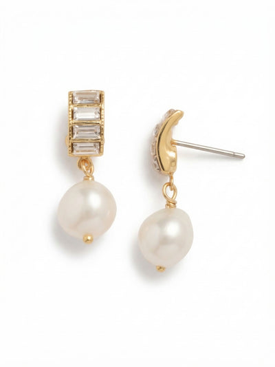 Cressida Dangle Earrings - EGJ12BGCRY - <p>A vertical stack of crisp, geometric baguette crystals curves gently to sit close to the ear, catching the light with a sharp brilliance. Suspended just below, a single white pearl provides a soft contrast, shifting slightly as you turn your head. The lightweight post design secures firmly with an oversized comfort clutch, ensuring the geometric top stays properly aligned and feels completely natural all day. They bring a quiet refinement to both structured workwear and casual sweaters.</p><ul>
<li>Architectural stack of crisp baguette crystals contrasting with a soft pearl drop</li>
<li>Subtle curve to the crystal setting allows it to hug the ear naturally</li>
<li>Post with oversized comfort-clutch back</li>
<li>Protective e-coat finish for lasting wear</li>
<li>Includes signature organza pouch for gifting and travel</li>
</ul>