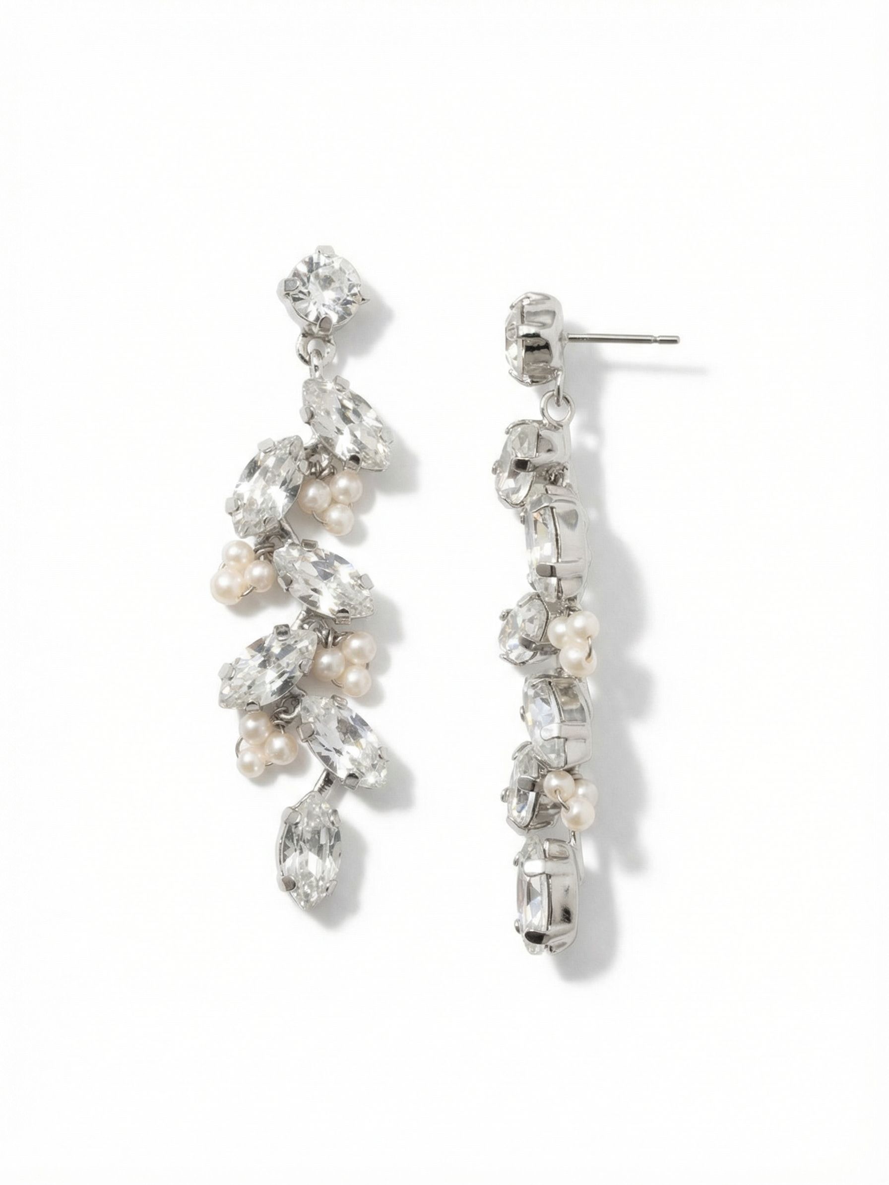 Hyacinth Statement Earrings - EGJ6PDMDP - <p>Sharp marquise cuts cascade downward, catching the light with every turn of the head. These elongated crystals are anchored on a flexible crystal-set chain, allowing the design to sway fluidly as you move. Clusters of miniature smooth pearls tuck between the sharp geometric stones, creating a quiet contrast of texture. At over two inches long, these drops command attention at conversation distance. They anchor securely in place with an oversized comfort clutch, keeping the weight gently balanced and the design sitting perfectly upright throughout the day.</p><ul>
<li>Fluid kette chain construction allows the crystal column to sway naturally</li>
<li>Sharp marquise-cut crystals contrasted with clusters of smooth pearl accents</li>
<li>Post with oversized comfort-clutch back</li>
<li>Protective e-coat finish for lasting wear</li>
<li>Includes signature organza pouch for gifting and travel</li>
</ul>