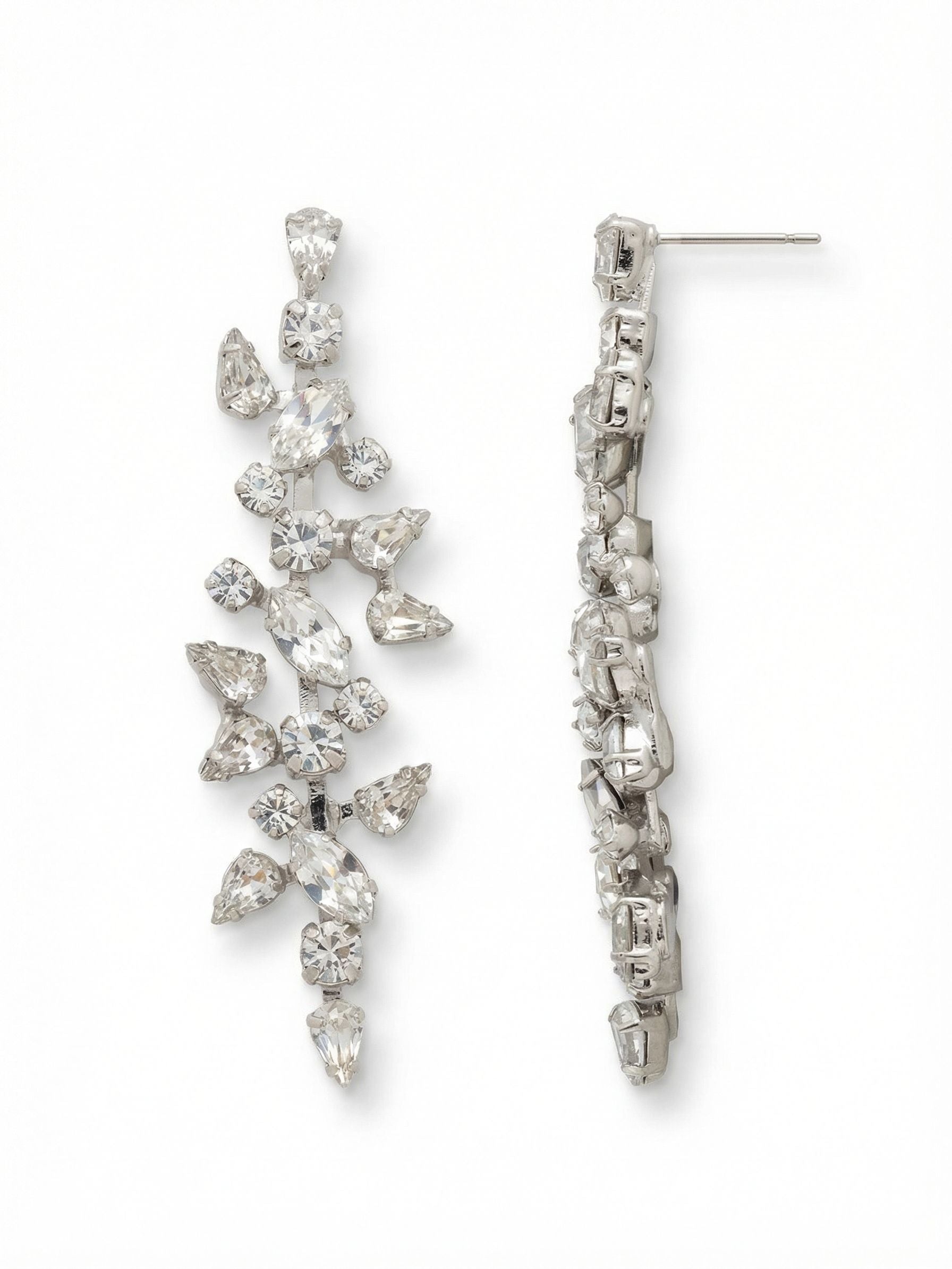 Daphne Statement Earrings - EGJ7PDCRY - <p>An intricate vine of clear crystals cascades two and a half inches down the neck in a fluid line of light. Pear, marquise, and round cuts branch outward from a flexible crystal channel chain. This asymmetrical arrangement catches movement from every angle while maintaining a balanced silhouette. Because a long statement piece requires serious support, the secure post pairs with an oversized comfort clutch to keep the earring anchored and completely upright all day.</p><ul>
<li>Interplay of pear, round, and marquise-cut crystals in a branching organic layout</li>
<li>Rigid central kette chain spine maintains the structured vertical alignment</li>
<li>Post with oversized comfort-clutch back</li>
<li>Protective e-coat finish for lasting wear</li>
<li>Includes signature organza pouch for gifting and travel</li>
</ul>