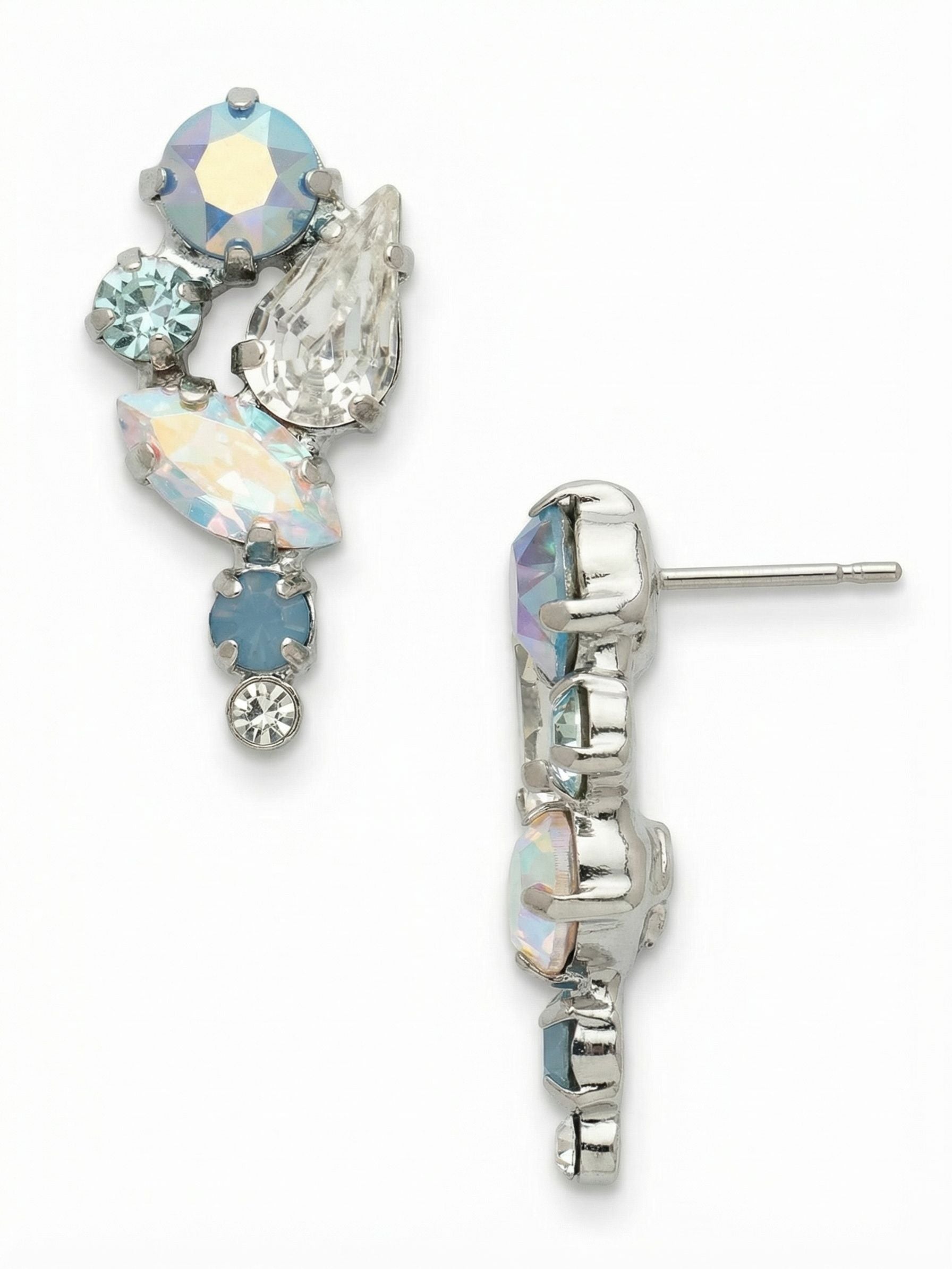Monday Dangle Earrings - EGK4PDRQ - <p>An asymmetrical cluster of icy blue opals and iridescent crystals catches the light with every turn of your head. The deliberate mix of pear, marquise, and round cuts creates a subtle visual rhythm, throwing cool, shifting tones that quietly illuminate the face. While the arrangement brings significant texture and presence, the post design wears effortlessly all day, anchored close to the skin by an oversized comfort clutch that keeps the weight perfectly balanced.</p><ul>
<li>Asymmetrical cascade of mixed round, pear, and marquise crystals</li>
<li>Opalescent blue tones that shift dynamically in natural light</li>
<li>Post with oversized comfort-clutch back</li>
<li>Protective e-coat finish for lasting wear</li>
<li>Includes signature organza pouch for gifting and travel</li>
</ul>