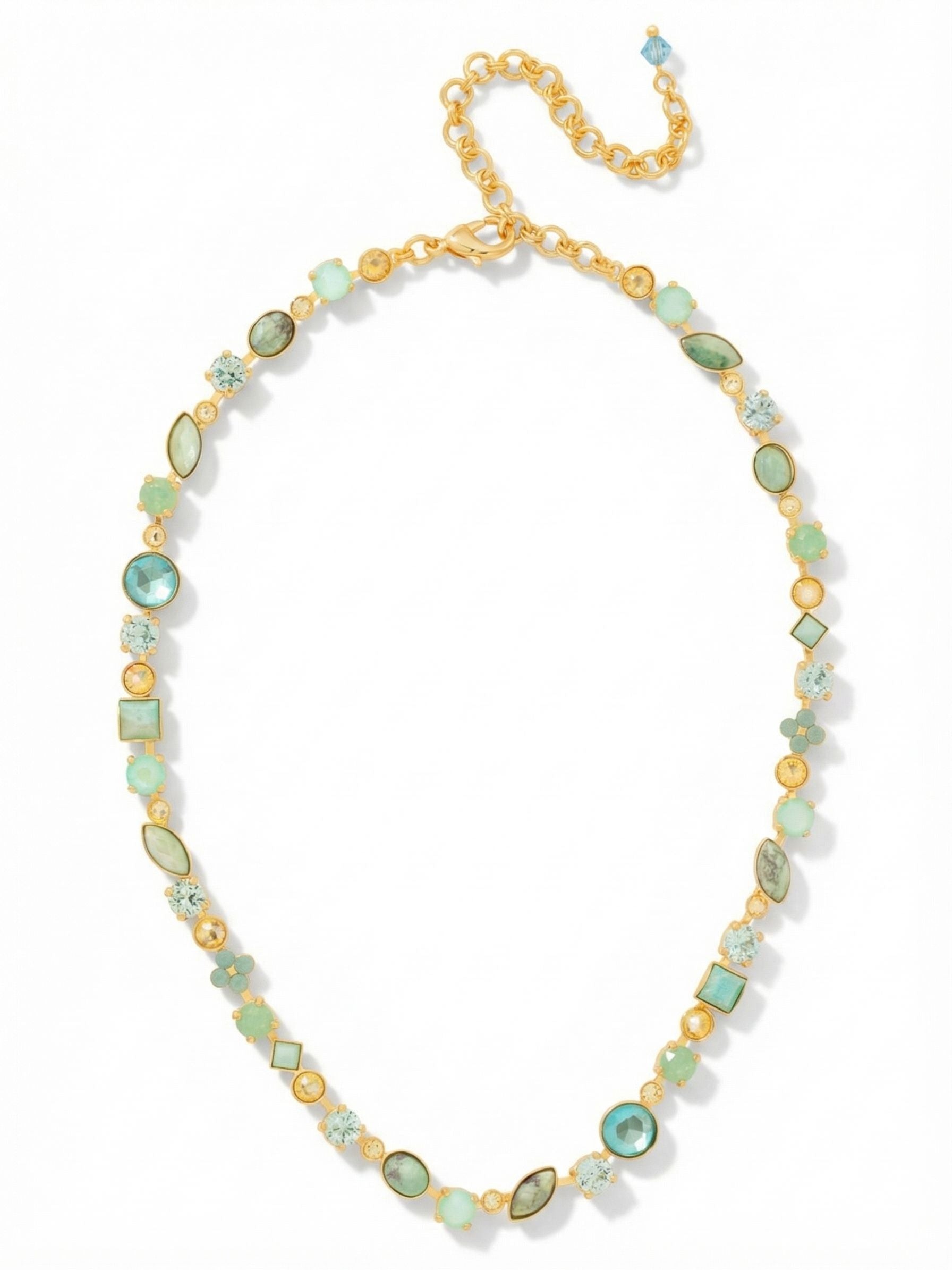 Classic Tee-Shirt Tennis Necklace - NAQ3BGCSD - <p>A continuous flow of aquamarine crystals and green turquoise dyed howlite circles the collarbone, catching the natural light as you move. Built on a flexible channel chain, the design traces your neckline evenly without twisting or flipping. The varied cuts break up the silhouette with unexpected geometry, blending opaque textures with bright, faceted depth. Thanks to the integrated extension chain, you can easily alter the drop to frame a simple cotton crewneck or layer cleanly under an open collar.</p><ul>
<li>Unexpected mix of faceted crystals and opaque howlite stones</li>
<li>Flexible crystal channel chain maintains an even drape</li>
<li>Lobster claw clasp</li>
<li>4-inch adjustable extension chain</li>
<li>Protective e-coat finish for lasting wear</li>
<li>Includes signature organza pouch for gifting and travel</li>
</ul>