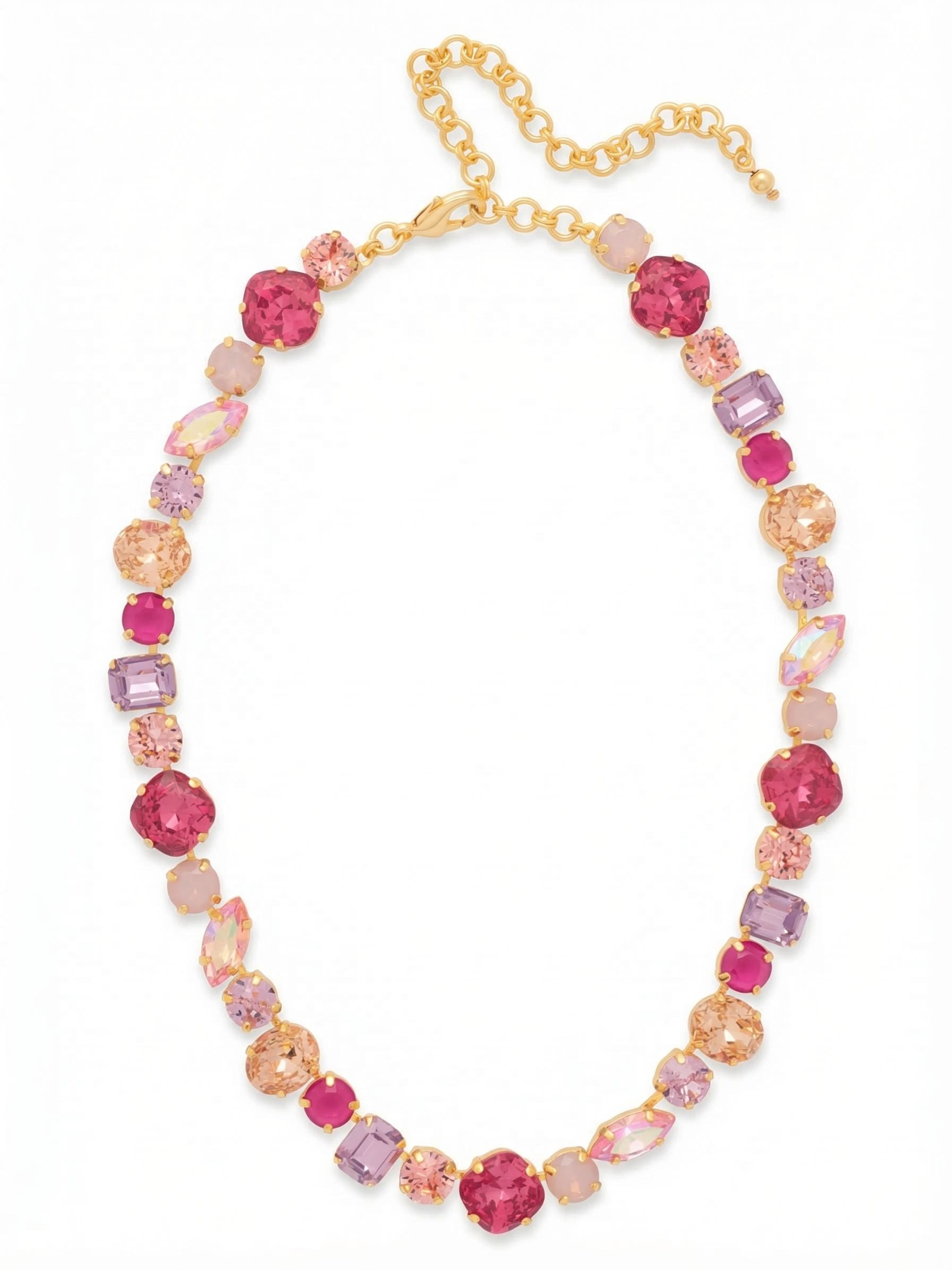 Teddy Tennis Necklace - NBX101BGPRO - <p>This necklace forms a continuous band of shifting geometry right at your collarbone. Deep pink cushion-cut crystals intermingle with violet emerald shapes, soft oval silhouettes, and iridescent marquise stones. Set closely together on an articulated chain base, the varied shapes create a lively rhythm that catches light from every angle. The bright gold-tone metal warms the vivid blush and berry hues. A built-in extension chain lets you adjust the length, making it easy to wear tight against the neck or dropped slightly lower into an open collar.</p><ul>
<li>Mixed crystal cuts create an irregular geometric rhythm</li>
<li>Articulated channel construction allows the stones to drape naturally</li>
<li>Lobster claw clasp</li>
<li>4-inch adjustable extension chain</li>
<li>Protective e-coat finish for lasting wear</li>
<li>Includes signature organza pouch for gifting and travel</li>
</ul>