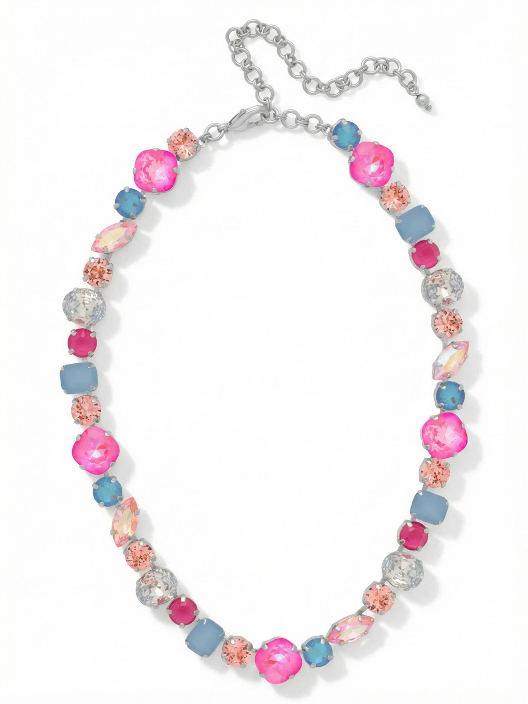 Teddy Tennis Necklace - NBX101PDPBZ - <p>A dynamic take on the traditional tennis style, this necklace builds an unbroken line of contrasting crystal shapes. Sharp emerald cuts sit beside smooth ovals and elongated marquise stones, creating a structured visual rhythm right at the collar. The mix of vibrant pinks and soft opal blues catches the light from multiple angles, bringing a cool brightness to the face. Constructed on a continuous channel chain, the piece drapes fluidly and adapts to different necklines using the built-in extension. It adds immediate weight and color to a simple button-down.</p><ul>
<li>Contrasting mix of geometric and soft crystal cuts creates a structured visual rhythm</li>
<li>Continuous channel chain construction ensures the stones drape fluidly around the neck</li>
<li>Lobster claw clasp</li>
<li>4-inch adjustable extension chain</li>
<li>Protective e-coat finish for lasting wear</li>
<li>Includes signature organza pouch for gifting and travel</li>
</ul>