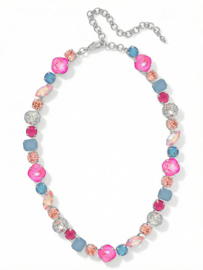 Teddy Tennis Necklace - NBX101PDPBZ - <p>A dynamic take on the traditional tennis style, this necklace builds an unbroken line of contrasting crystal shapes. Sharp emerald cuts sit beside smooth ovals and elongated marquise stones, creating a structured visual rhythm right at the collar. The mix of vibrant pinks and soft opal blues catches the light from multiple angles, bringing a cool brightness to the face. Constructed on a continuous channel chain, the piece drapes fluidly and adapts to different necklines using the built-in extension. It adds immediate weight and color to a simple button-down.</p><ul>
<li>Contrasting mix of geometric and soft crystal cuts creates a structured visual rhythm</li>
<li>Continuous channel chain construction ensures the stones drape fluidly around the neck</li>
<li>Lobster claw clasp</li>
<li>4-inch adjustable extension chain</li>
<li>Protective e-coat finish for lasting wear</li>
<li>Includes signature organza pouch for gifting and travel</li>
</ul>