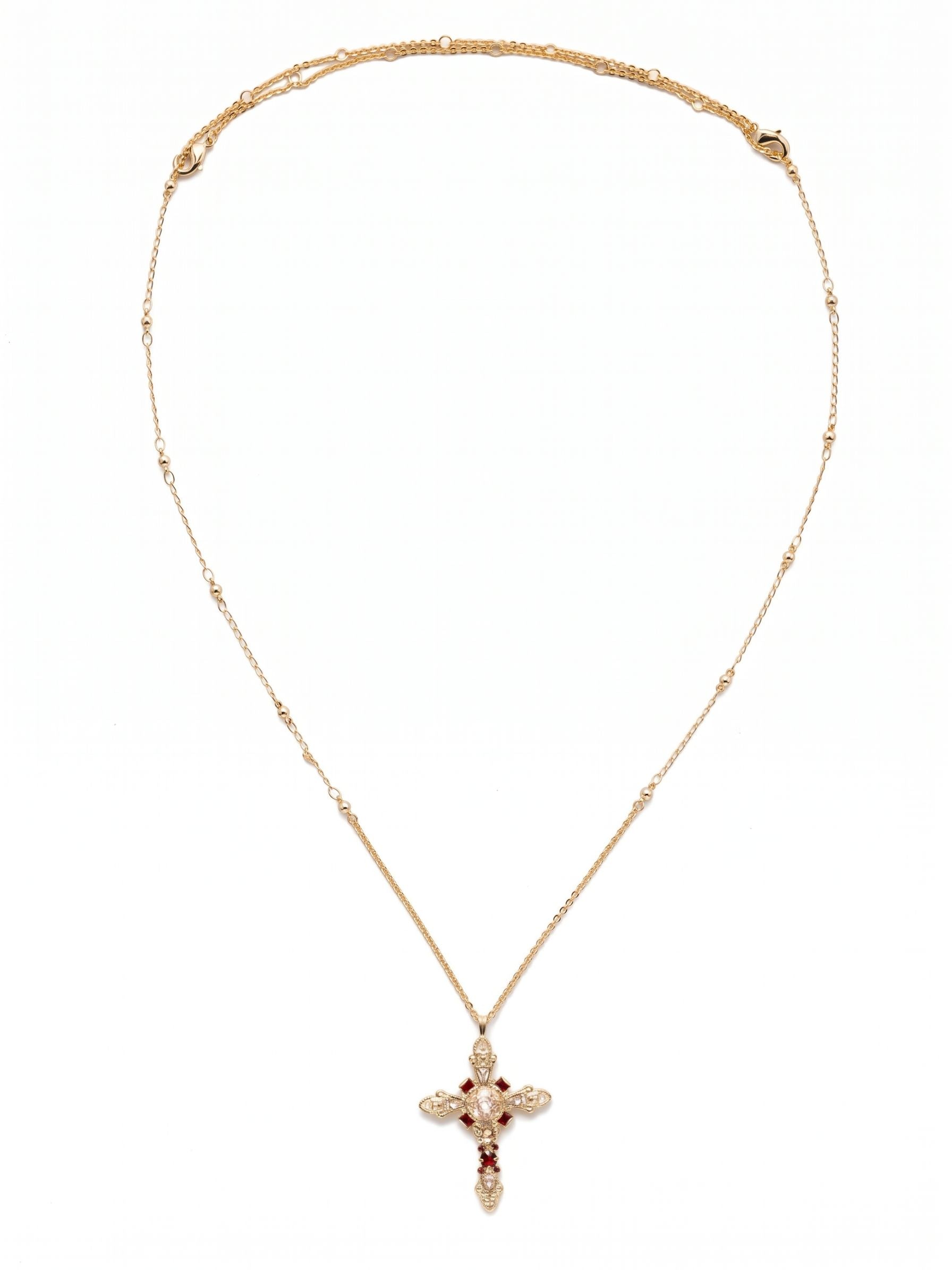 Elowen Pendant Necklace - NDS3BGSRC - <p>A thirty-two inch chain creates a sweeping vertical line, dropping this intricate pendant low on the torso for an elongated drape. The design balances a central cushion-cut crystal with delicate pear shapes, punctuated by deep red Siam accents that draw the eye. Small metallic beads spaced along the chain add subtle texture that catches the light in motion. The generous length lends a natural sense of ease, anchoring layered chains or bringing distinct character to a simple knit.</p><ul>
<li>Structured arrangement of pear and cushion cut crystals creates an intricate geometric silhouette</li>
<li>Delicate bead accents along the chain provide subtle texture and catch the light</li>
<li>Lobster claw clasp</li>
<li>Protective e-coat finish for lasting wear</li>
<li>Includes signature organza pouch for gifting and travel</li>
</ul>