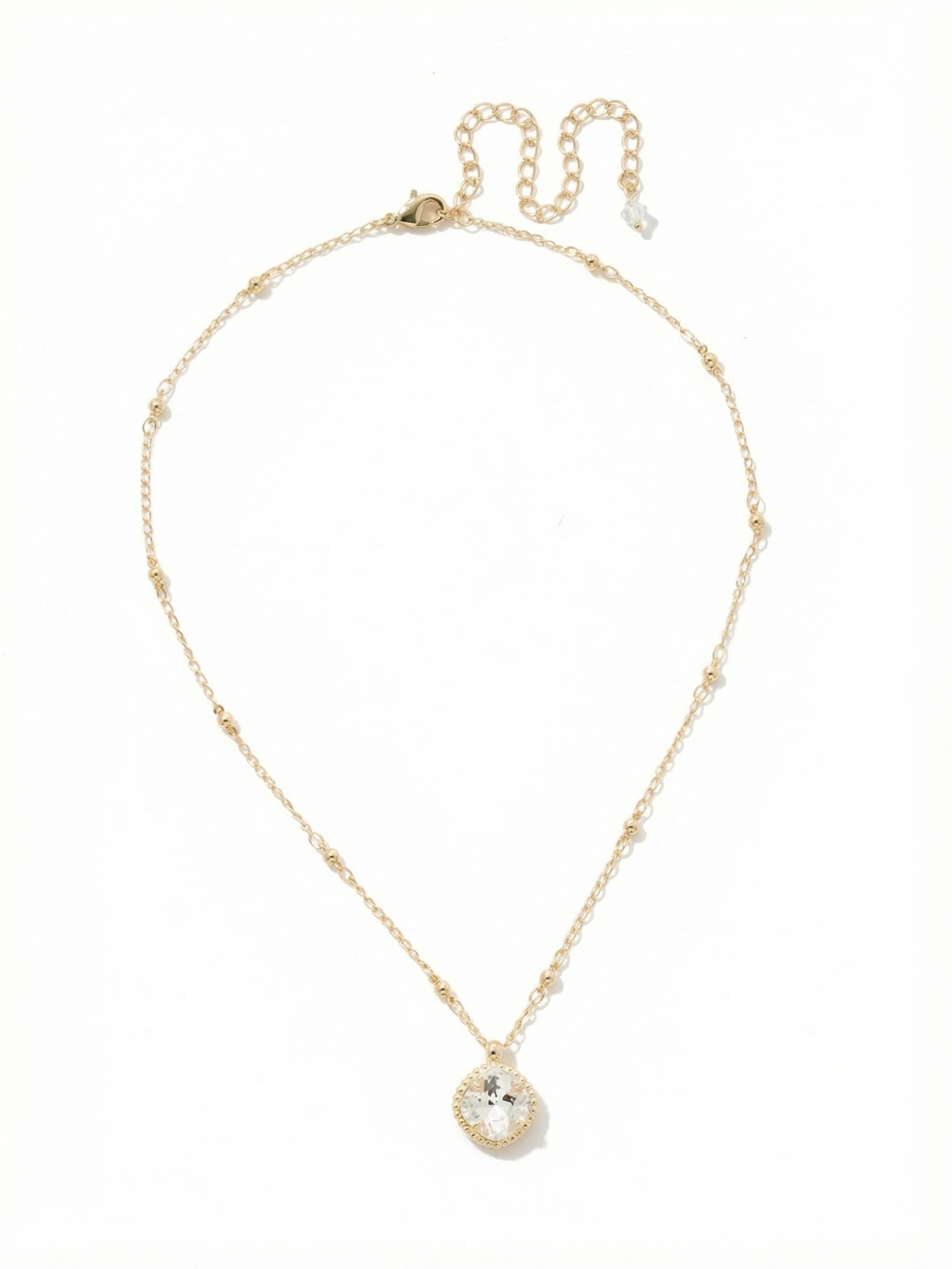 Cushion-Cut Pendant Necklace - NDS50BGCRY - <p>A single cushion-cut crystal anchors this quiet, everyday pendant. The substantial twelve-millimeter stone catches natural light, bringing a subtle brightness to the face. It suspends from a slender chain that alternates tiny ball and cable links, adding delicate textural contrast against bare skin. Designed to find the hollow of the collarbone, this piece layers easily with longer chains but holds its own as a daily signature. An extension chain allows you to tailor the drop to any neckline.</p><ul>
<li>Alternating ball and cable chain links create delicate texture</li>
<li>A single twelve-millimeter clear crystal with classic cushion faceting</li>
<li>Lobster claw clasp</li>
<li>4-inch adjustable extension chain</li>
<li>Protective e-coat finish for lasting wear</li>
<li>Includes signature organza pouch for gifting and travel</li>
</ul>