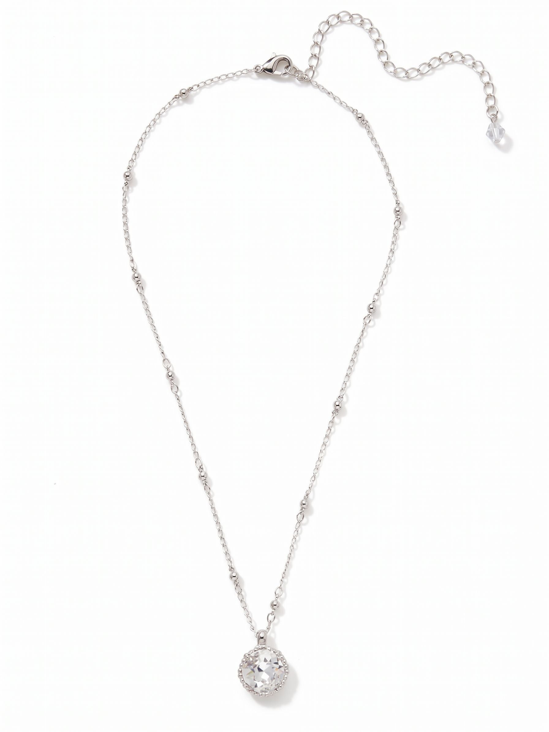 Cushion-Cut Pendant Necklace - NDS50PDCRY - <p>A single, substantial cushion-cut crystal anchors this necklace, drawing light directly to the collarbone. The stone is suspended from a delicate mixed-link chain, where polished metallic beads break up the traditional cable pattern to catch the light from multiple angles. It has a quiet presence that layers easily with other delicate pieces or stands perfectly well on its own. An adjustable extension allows you to tailor the drape to suit your neckline.</p><ul>
<li>Substantial cushion-cut focal crystal creates a distinct center point</li>
<li>Interspersed metallic beads add subtle texture to the delicate cable chain</li>
<li>Lobster claw clasp</li>
<li>4-inch adjustable extension chain</li>
<li>Protective e-coat finish for lasting wear</li>
<li>Includes signature organza pouch for gifting and travel</li>
</ul>