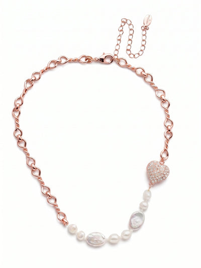 Venus Tennis Necklace - NER10RGCRY - <p>The eye is immediately drawn to the asymmetrical balance of this delicate necklace. An open link chain loops around the neck before giving way to an unexpected off-center focal point at the collarbone. Here, a puffed heart fully paved in round-cut crystals anchors a short sequence of white baroque and oval coin pearls. The design creates a tactile contrast between the organic, irregular pearl shapes and the precise geometric sparkle of the heart. An included extension chain lets you adjust the drape to suit the neckline of your top.</p><ul>
<li>Asymmetrical arrangement of pearls and an off-center heart</li>
<li>Contrast between organic pearl shapes and structured crystals</li>
<li>Lobster claw clasp</li>
<li>4-inch adjustable extension chain</li>
<li>Protective e-coat finish for lasting wear</li>
<li>Includes signature organza pouch for gifting and travel</li>
</ul>