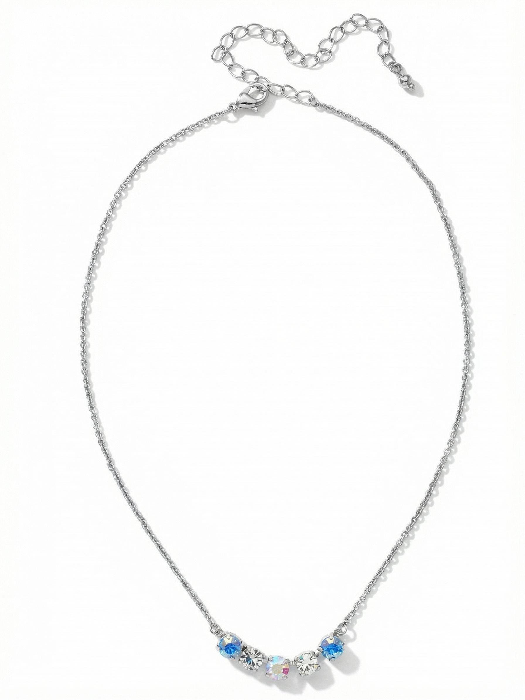 Shaughna Tennis Necklace - NFC84PDRQ - <p>A delicate cable chain anchors a focused cluster of five round crystals, creating a quiet point of light at the collarbone. The center grouping blends clear crystal with iridescent and soft blue opal stones that catch subtle shifts in color as you move. The fine construction makes it an effortless piece to layer with longer strands or wear entirely on its own. An integrated extension chain allows you to easily adjust the drop to suit different necklines.</p><ul>
<li>Five centered round crystals transition from blue opal to an iridescent core</li>
<li>Fine cable chain construction creates a delicate drape and easy layering profile</li>
<li>Lobster claw clasp</li>
<li>4-inch adjustable extension chain</li>
<li>Protective e-coat finish for lasting wear</li>
<li>Includes signature organza pouch for gifting and travel</li>
</ul>