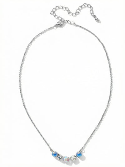 Shaughna Tennis Necklace - NFC84PDRQ - <p>A delicate cable chain anchors a focused cluster of five round crystals, creating a quiet point of light at the collarbone. The center grouping blends clear crystal with iridescent and soft blue opal stones that catch subtle shifts in color as you move. The fine construction makes it an effortless piece to layer with longer strands or wear entirely on its own. An integrated extension chain allows you to easily adjust the drop to suit different necklines.</p><ul>
<li>Five centered round crystals transition from blue opal to an iridescent core</li>
<li>Fine cable chain construction creates a delicate drape and easy layering profile</li>
<li>Lobster claw clasp</li>
<li>4-inch adjustable extension chain</li>
<li>Protective e-coat finish for lasting wear</li>
<li>Includes signature organza pouch for gifting and travel</li>
</ul>