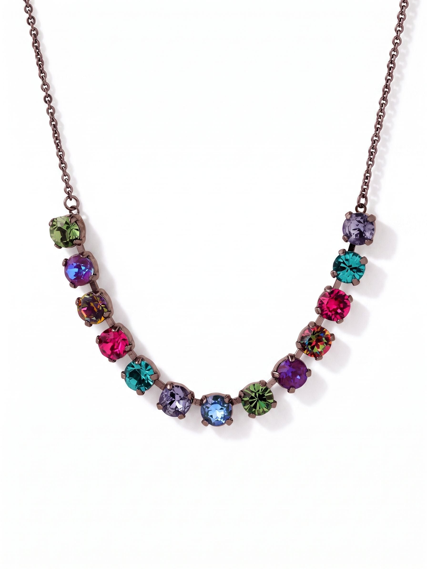 Jayda Tennis Necklace - NFC86GMNNI - <p>A curving line of vividly colored, round-cut crystals rests gently along the collarbone. Set in dark metal, these rich jewel tones catch the light as you move. By suspending a vibrant focal point from a simple cable chain, this design gives you bright visual impact with an easy, lightweight feel. The adjustable length lets you tailor the drop to your neckline, making it a natural starting point for a layered look or a distinct pop of color on its own.</p><ul>
<li>Symmetrical curve of vivid multicolored round-cut stones</li>
<li>Transition from a crystal-set center to a lightweight cable chain</li>
<li>Lobster claw clasp</li>
<li>4-inch adjustable extension chain</li>
<li>Includes signature organza pouch for gifting and travel</li>
</ul>