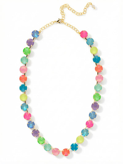 Mara Tennis Necklace - NFD75BGCCA - <p>Thirty large crystals form a bold circle of vibrant color around the neck. The fluid chain construction gives this piece a satisfying weight, allowing the stones to settle naturally along the collarbone without flipping as you move. Bright flashes of opal, electric pink, and saturated blue catch the light across a rhythmic mix of faceted cuts. An included four-inch extension chain lets you tailor the drape, so you can wear it high as a close collar or drop it lower to frame an open neckline.</p><ul>
<li>Ten distinct crystal colors arranged in a bold repeating spectrum</li>
<li>Fluid chain construction prevents the large stones from flipping</li>
<li>Lobster claw clasp</li>
<li>Protective e-coat finish for lasting wear</li>
<li>Includes signature organza pouch for gifting and travel</li>
</ul>