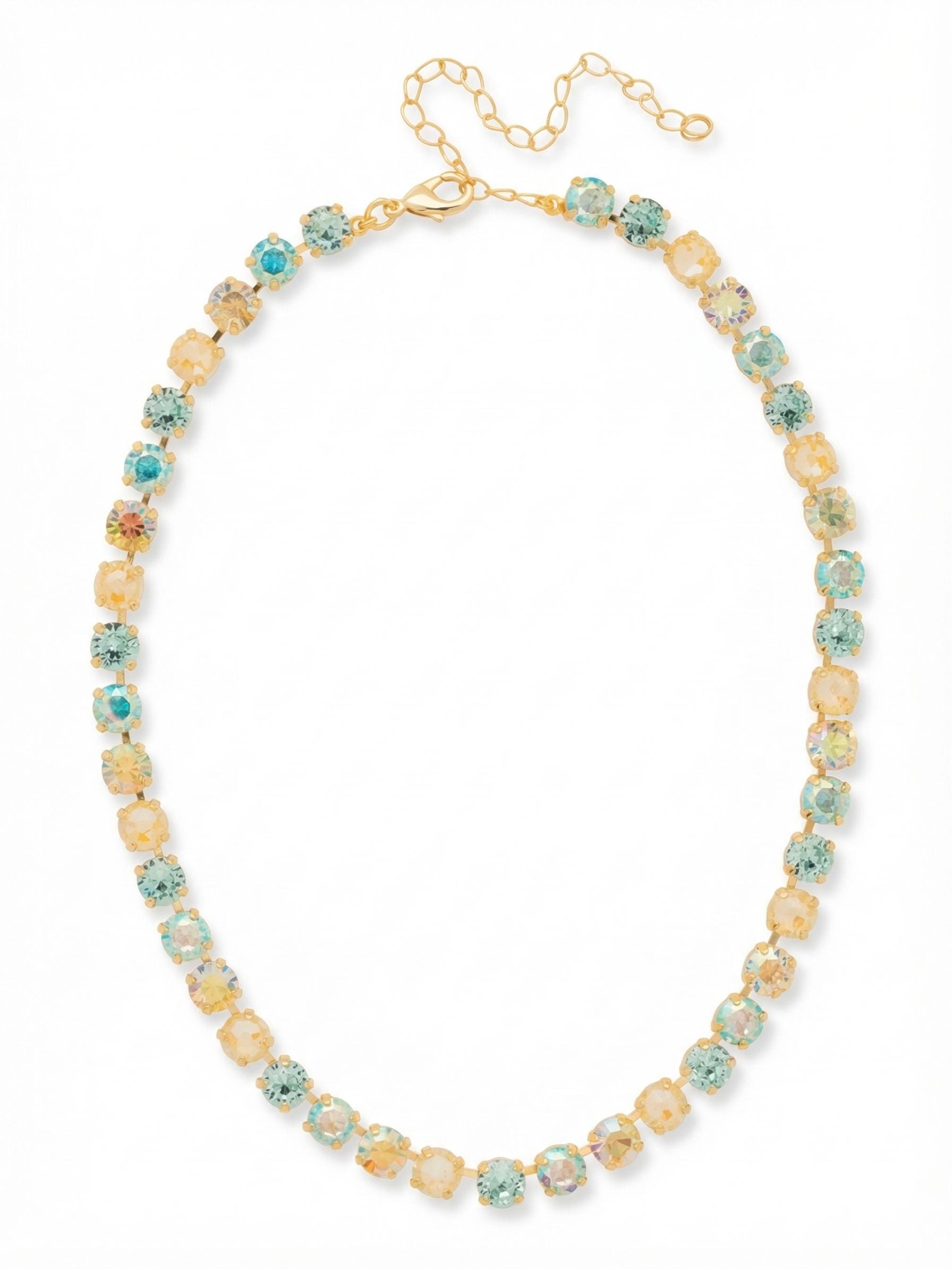 Matilda Tennis Necklace - NFJ4BGCSD - <p>A continuous line of soft color wraps the collarbone in this classic tennis silhouette. Warm topaz and cool aquamarine crystals alternate along a flexible channel chain, catching the light as you move. The closely set stones create an unbroken rhythm that feels substantial yet easy to wear throughout the day. The bright gold-tone setting warms the palette of pale blues and yellows, bringing a subtle coastal energy to your neckline. An extension chain allows you to adjust the drop, letting the necklace rest exactly where you want it.</p><ul>
<li>Fluid kette chain construction ensures a flexible drape along the collarbone</li>
<li>Alternating warm topaz and cool aquamarine stones with subtle iridescent finishes</li>
<li>Lobster claw clasp</li>
<li>4-inch adjustable extension chain</li>
<li>Protective e-coat finish for lasting wear</li>
<li>Includes signature organza pouch for gifting and travel</li>
</ul>