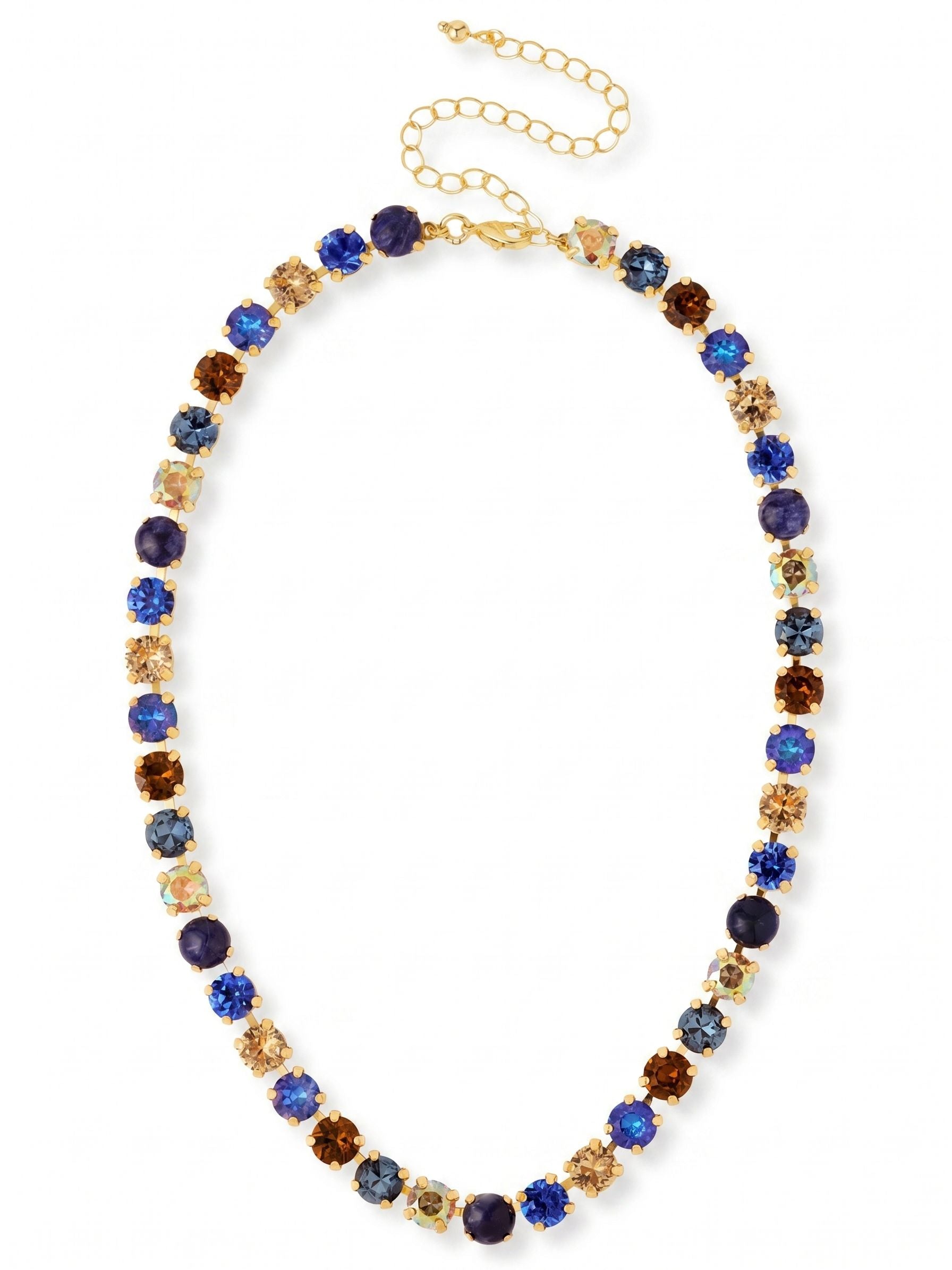 Matilda Tennis Necklace - NFJ4BGDNM - <p>A seamless line of faceted crystals and opaque sodalite creates a rich textural rhythm along the collarbone. Deep sapphire and muted montana blue contrast with warm smoked topaz, catching the light organically as you move. Built on a flexible channel chain, the stones remain precisely aligned without twisting or flipping during wear. The adjustable extension chain allows you to tailor the drape, making it simple to layer with longer chains or wear high on the neck as a daily signature.</p><ul>
<li>Alternating faceted crystals and smooth sodalite for textural contrast</li>
<li>Flexible channel chain construction prevents stones from twisting</li>
<li>Lobster claw clasp</li>
<li>4-inch adjustable extension chain</li>
<li>Protective e-coat finish for lasting wear</li>
<li>Includes organza pouch for gifting and travel</li>
</ul>