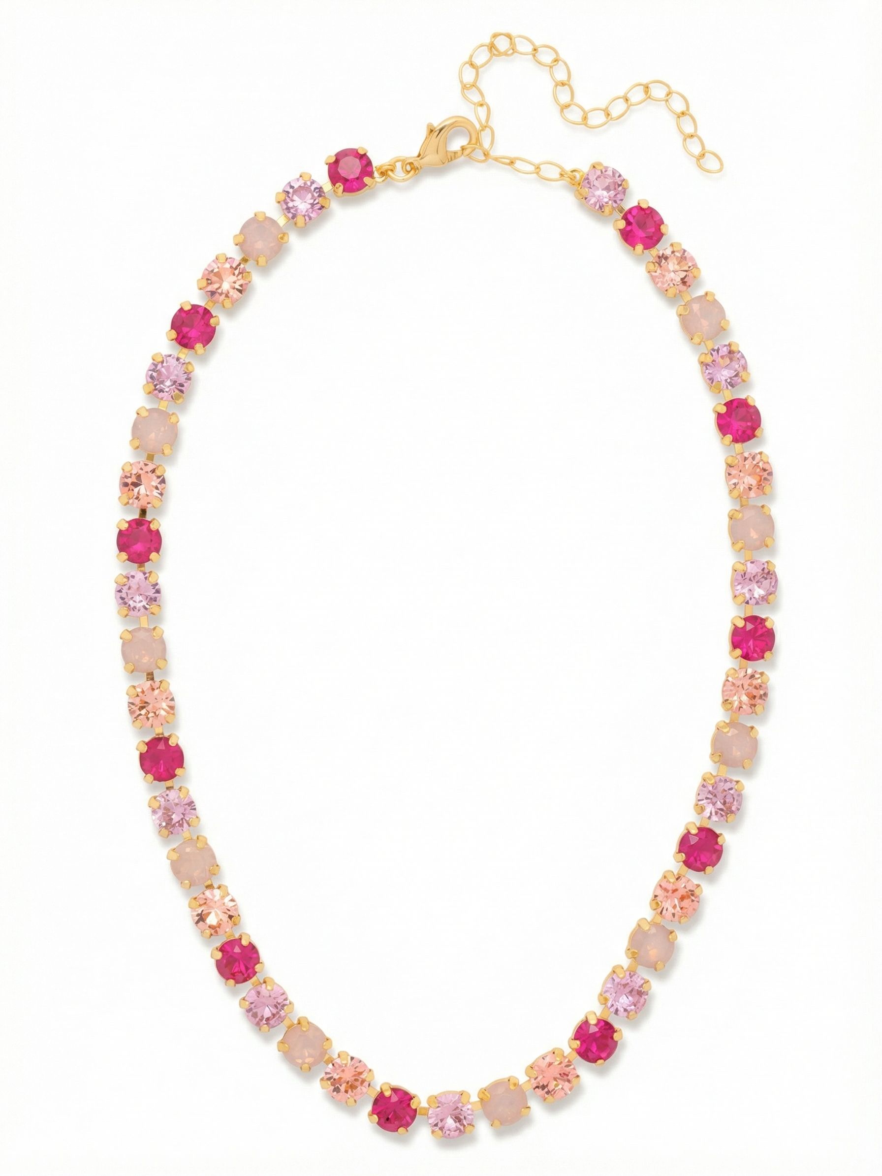 Matilda Tennis Necklace - NFJ4BGPRO - <p>An unbroken line of round cut crystals circles the collarbone, creating a rhythmic pattern of warm light. The design alternates translucent blush and bright peach stones with flashes of deeply saturated pink lacquer, building a rich progression of color that catches the eye as you move. Crafted on a flexible channel chain, the piece drapes fluidly along the neckline. A built in extension chain allows you to tailor the drop, letting it rest comfortably right at the collar of a crisp shirt or drop slightly lower over an open neckline.</p><ul>
<li>Alternating pattern of translucent and opaque pink stones</li>
<li>Flexible crystal set channel chain for fluid drape</li>
<li>Lobster claw clasp</li>
<li>4-inch adjustable extension chain</li>
<li>Protective e-coat finish for lasting wear</li>
<li>Includes signature organza pouch for gifting and travel</li>
</ul>