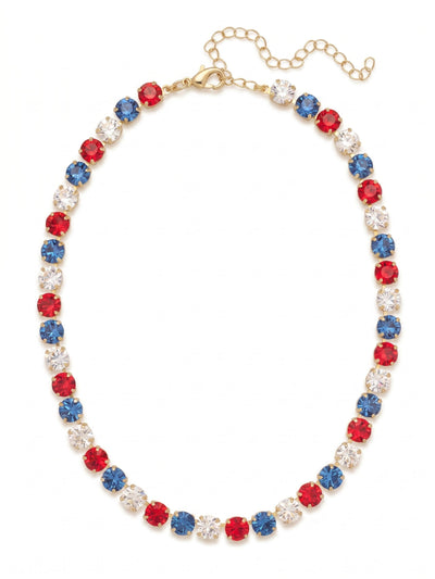 Matilda Tennis Necklace - NFJ4BGUSA - <p>A classic silhouette built for genuine impact. The Matilda wraps the neckline in a steady rhythm of large, round-cut crystals. Vibrant red, deep blue, and pure clear stones alternate along a flexible chain that conforms naturally to the collarbone. The substantial weight of the crystals grounds the piece with a quiet, confident presence, and the bright gold-tone setting warms up the crisp palette. Thanks to the extension chain, it transitions easily from a close collar profile to a more relaxed drape to suit your daily rotation.</p><ul>
<li>Alternating sequence of large round-cut crystals in a vivid tri-color palette</li>
<li>Fluid chain construction that drapes naturally across the collarbone</li>
<li>Lobster claw clasp</li>
<li>4-inch adjustable extension chain</li>
<li>Protective e-coat finish for lasting wear</li>
<li>Includes organza pouch for gifting and travel</li>
</ul>