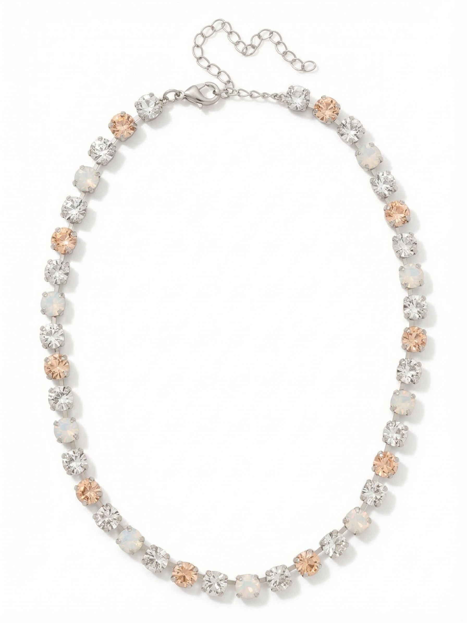 Matilda Tennis Necklace - NFJ4PDCLA - <p>A continuous line of round-cut crystals creates a delicate rhythm at the collarbone. The design alternates warm silk, milky white opal, and sharp clear crystal for a subtle, dimensional effect that reads like fine lacework. Built on a traditional kette chain, the setting allows each stone to capture light from multiple angles while moving fluidly with your neckline. An extension chain lets you adjust the drape, ensuring a precise fit whether worn closely as a choker or relaxed as a standalone collar.</p><ul>
<li>Continuous kette chain construction allows fluid movement along the neckline</li>
<li>Alternating silk, clear, and white opal crystals create a soft, dimensional pattern</li>
<li>Lobster claw clasp</li>
<li>4-inch adjustable extension chain</li>
<li>Protective e-coat finish for lasting wear</li>
<li>Includes signature organza pouch for gifting and travel</li>
</ul>