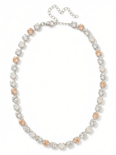 Matilda Tennis Necklace - NFJ4PDCLA - <p>A continuous line of round-cut crystals creates a delicate rhythm at the collarbone. The design alternates warm silk, milky white opal, and sharp clear crystal for a subtle, dimensional effect that reads like fine lacework. Built on a traditional kette chain, the setting allows each stone to capture light from multiple angles while moving fluidly with your neckline. An extension chain lets you adjust the drape, ensuring a precise fit whether worn closely as a choker or relaxed as a standalone collar.</p><ul>
<li>Continuous kette chain construction allows fluid movement along the neckline</li>
<li>Alternating silk, clear, and white opal crystals create a soft, dimensional pattern</li>
<li>Lobster claw clasp</li>
<li>4-inch adjustable extension chain</li>
<li>Protective e-coat finish for lasting wear</li>
<li>Includes signature organza pouch for gifting and travel</li>
</ul>