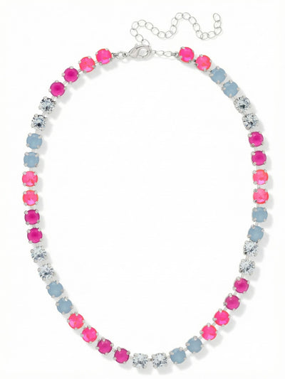 Matilda Tennis Necklace - NFJ4PDPBZ - <p>A continuous line of color defines this tennis necklace. The design alternates blocks of bright peony pink lacquer and milky air blue opal alongside sharp hits of light sapphire. Built on a flexible kette chain, the round crystals drape naturally along the collarbone without catching or twisting. At a quarter inch wide, it has enough visual weight to anchor an open neckline on its own but layers easily with finer chains. The piece includes an extension chain so you can adjust the drop to suit your exact collar shape.</p><ul>
<li>Alternating blocks of opaque pink lacquer and milky blue opal round crystals</li>
<li>Fluid kette chain construction allows the crystals to drape naturally</li>
<li>Lobster claw clasp</li>
<li>4-inch adjustable extension chain</li>
<li>Protective e-coat finish for lasting wear</li>
<li>Includes signature organza pouch for gifting and travel</li>
</ul>