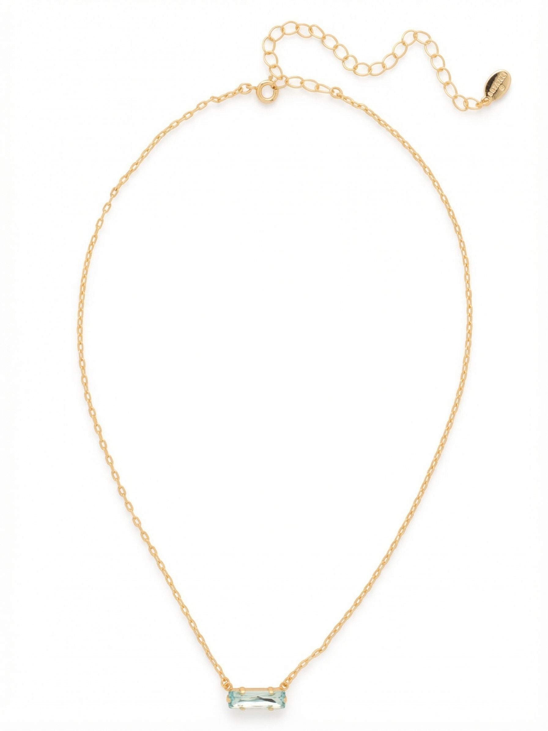 Bindi Pendant Necklace - NFL13BGAQU - <p>A single, horizontally set aquamarine crystal anchors this delicate cable chain. The elongated baguette cut catches the light with quiet precision, resting right at the collarbone. It brings a clean, structured element to your neckline that layers easily with other lengths or stands confidently on its own. An included extension chain lets you adjust the drop to find the exact placement for whatever top you choose to wear today.</p><ul>
<li>Horizontally set baguette crystal offers a clean, structural silhouette</li>
<li>Fine cable chain provides a delicate, weightless feel on the body</li>
<li>4-inch adjustable extension chain</li>
<li>Protective e-coat finish for lasting wear</li>
<li>Includes signature organza pouch for gifting and travel</li>
</ul>