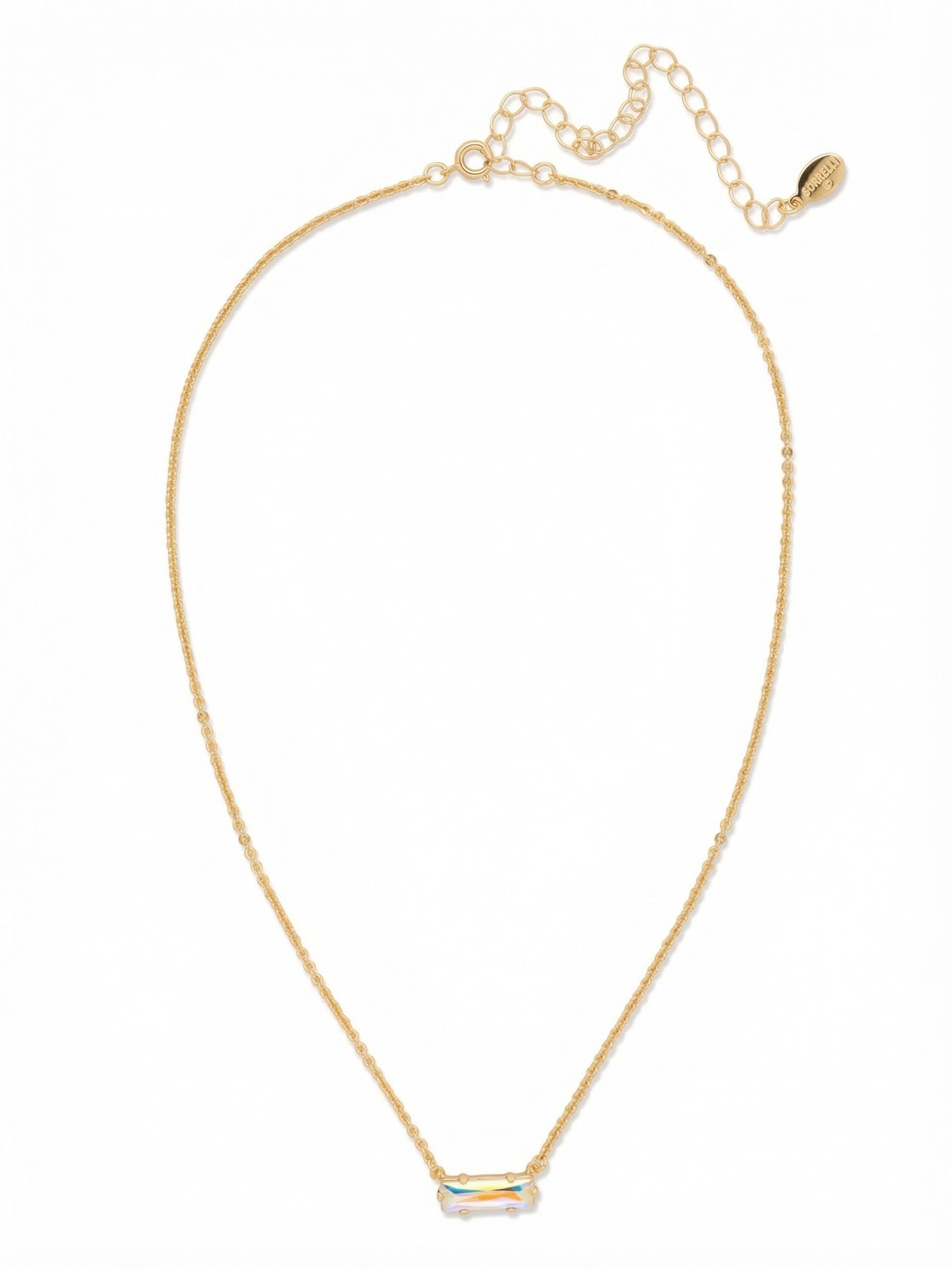 Bindi Pendant Necklace - NFL13BGCAB - <p>Suspended horizontally from a fine gold-tone cable chain, a single baguette-cut crystal rests right at the collarbone. The iridescent stone shifts in color as you move, catching the ambient light of a room. This necklace offers an understated, minimalist presence that layers naturally with thicker chains or stands quietly on its own. An adjustable extension chain allows you to tailor the drop to match your neckline exactly.</p><ul>
<li>East-west horizontal crystal setting</li>
<li>Delicate fine-link cable chain</li>
<li>4-inch adjustable extension chain</li>
<li>Protective e-coat finish for lasting wear</li>
<li>Includes signature organza pouch for gifting and travel</li>
</ul>