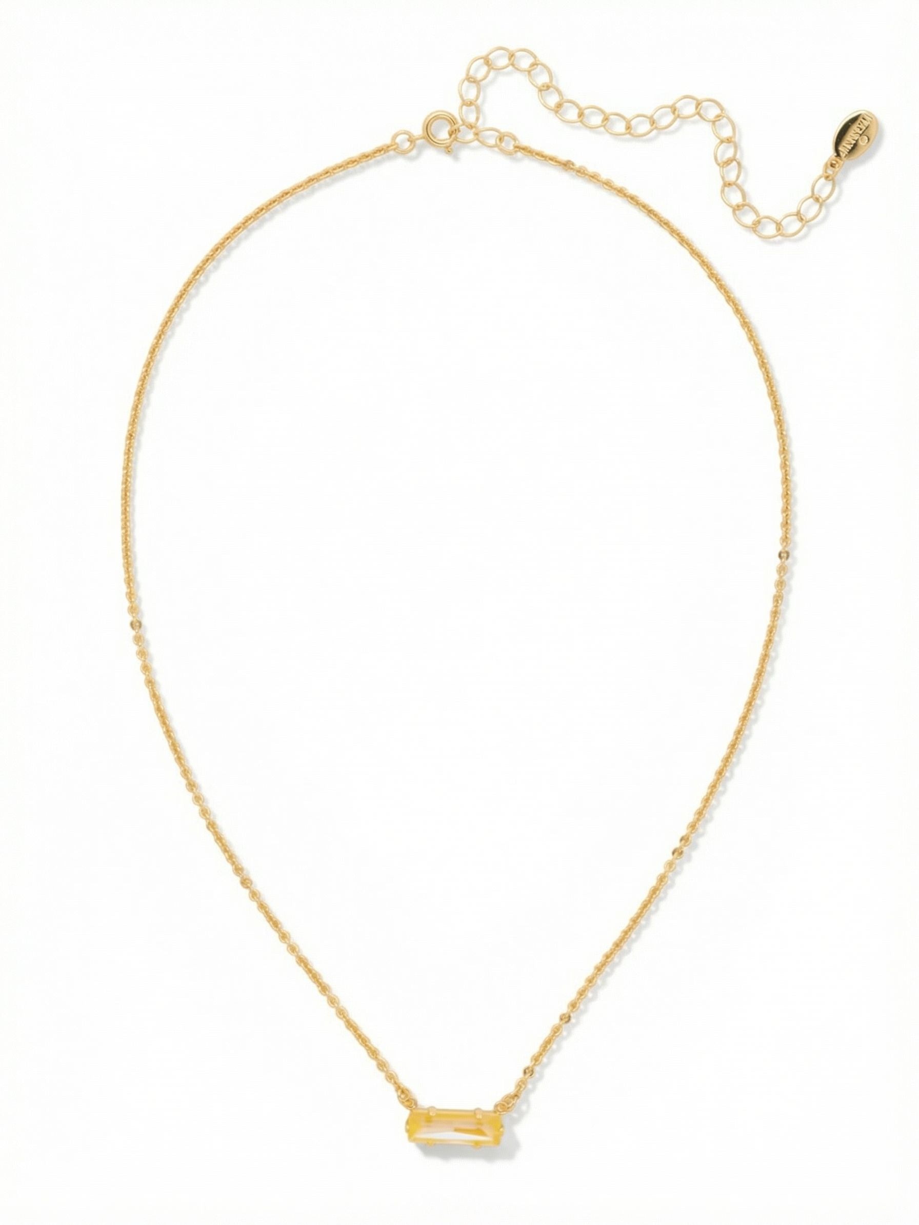 Bindi Pendant Necklace - NFL13BGLTD - <p>A single horizontal baguette-cut crystal anchors this delicate necklace. The warm topaz stone catches light with quiet intent, resting seamlessly at the collarbone. Suspended on a fine gold-tone cable chain, the fixed pendant design prevents the clasp from twisting to the front during wear. An included extension chain allows you to tailor the drop, making it a simple base layer beneath open shirts or a subtle finish to an open neckline.</p><ul>
<li>Single horizontally set baguette crystal offers a clean architectural line</li>
<li>Delicate cable chain profile keeps the focus entirely on the center stone</li>
<li>4-inch adjustable extension chain</li>
<li>Protective e-coat finish for lasting wear</li>
<li>Includes signature organza pouch for gifting and travel</li>
</ul>