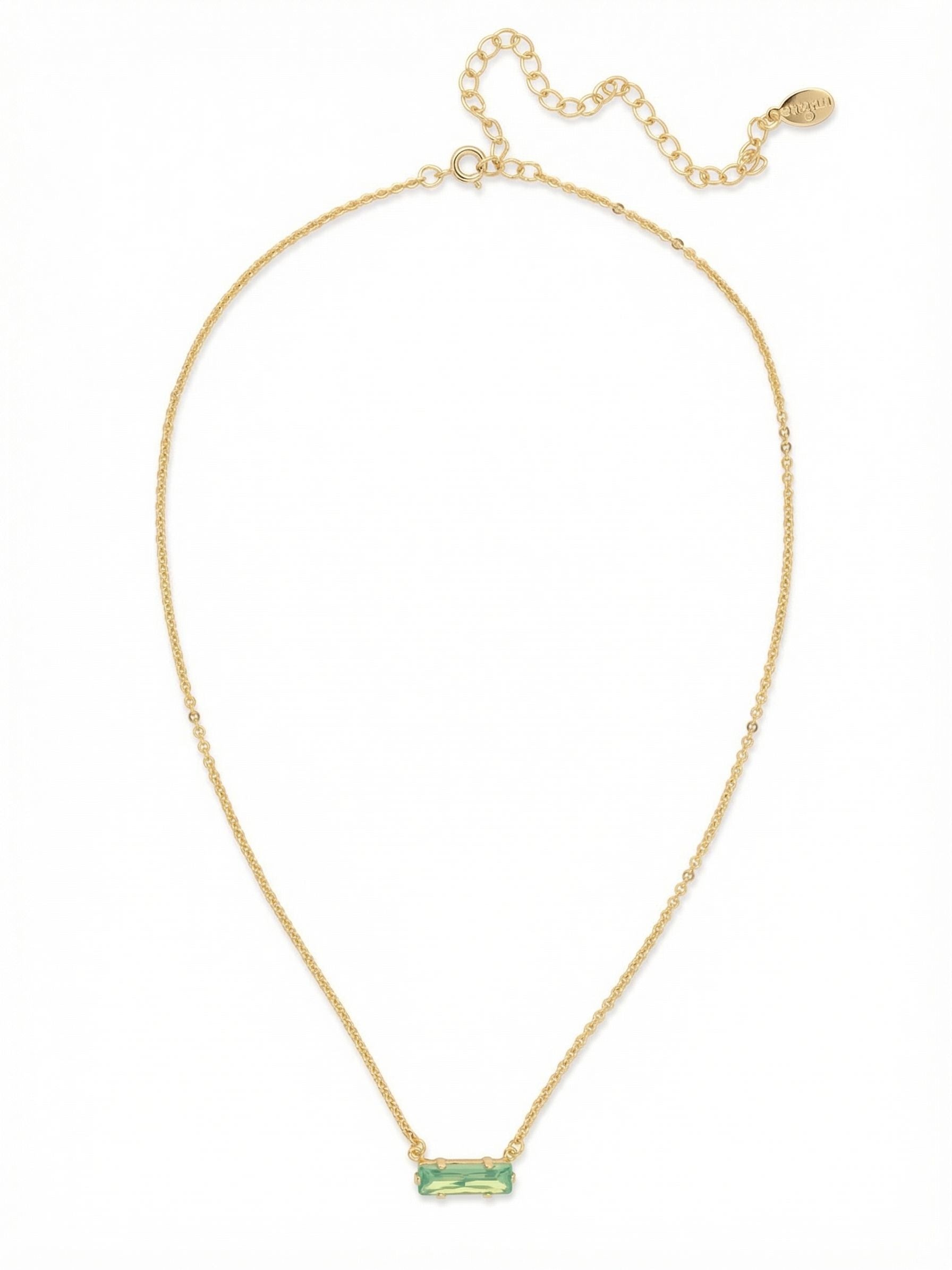 Bindi Pendant Necklace - NFL13BGPAC - <p>A single, east-west oriented baguette crystal forms the quiet focal point of this delicate necklace. The soft, shifting green tones of the Pacific Opal stone catch the light easily, suspended on a fine cable chain that rests lightly near the collarbone. It brings an effortless wash of color to a simple t-shirt or an open button-down. Thanks to the integrated extension chain, the drop adjusts seamlessly to find exactly the right placement for your daily neckline.</p><ul>
<li>Horizontally set baguette crystal provides a modern minimalist profile</li>
<li>Fine cable chain creates a delicate drape near the collarbone</li>
<li>4-inch adjustable extension chain</li>
<li>Protective e-coat finish for lasting wear</li>
<li>Includes signature organza pouch for gifting and travel</li>
</ul>