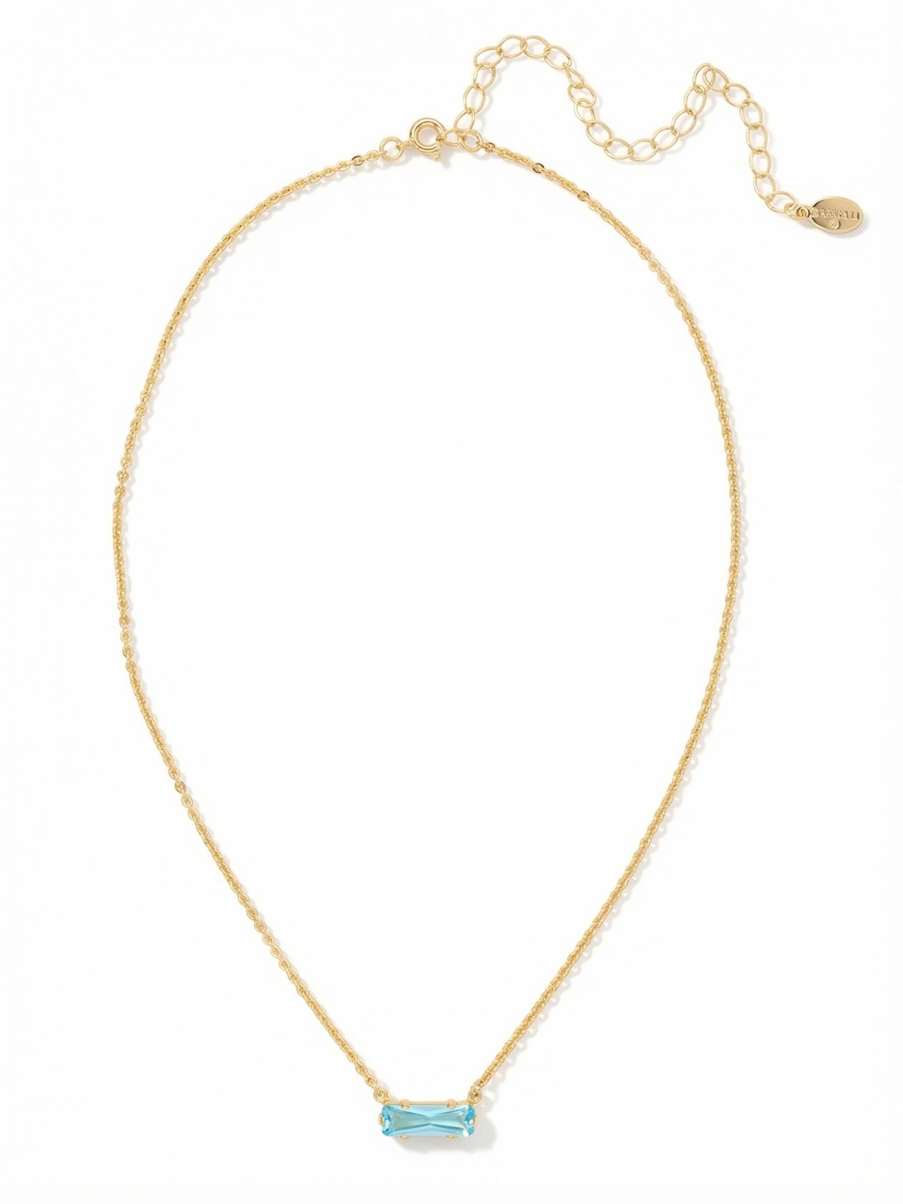 Bindi Pendant Necklace - NFL13BGSBD - <p>A single baguette crystal brings a quiet wash of bright blue to your neckline. Set horizontally along a delicate cable chain, the linear facets catch the light cleanly with a barely-there weight that feels effortless for daily wear. The built-in extension chain lets you adjust the drop to perfectly frame your collarbone, making this subtle piece just as easy to wear solo as it is to mix into a layered stack of gold chains.</p><ul>
<li>Horizontally set baguette crystal for a modern linear profile</li>
<li>Delicate fine cable chain designed for seamless layering</li>
<li>4-inch adjustable extension chain</li>
<li>Protective e-coat finish for lasting wear</li>
<li>Includes signature organza pouch for gifting and travel</li>
</ul>