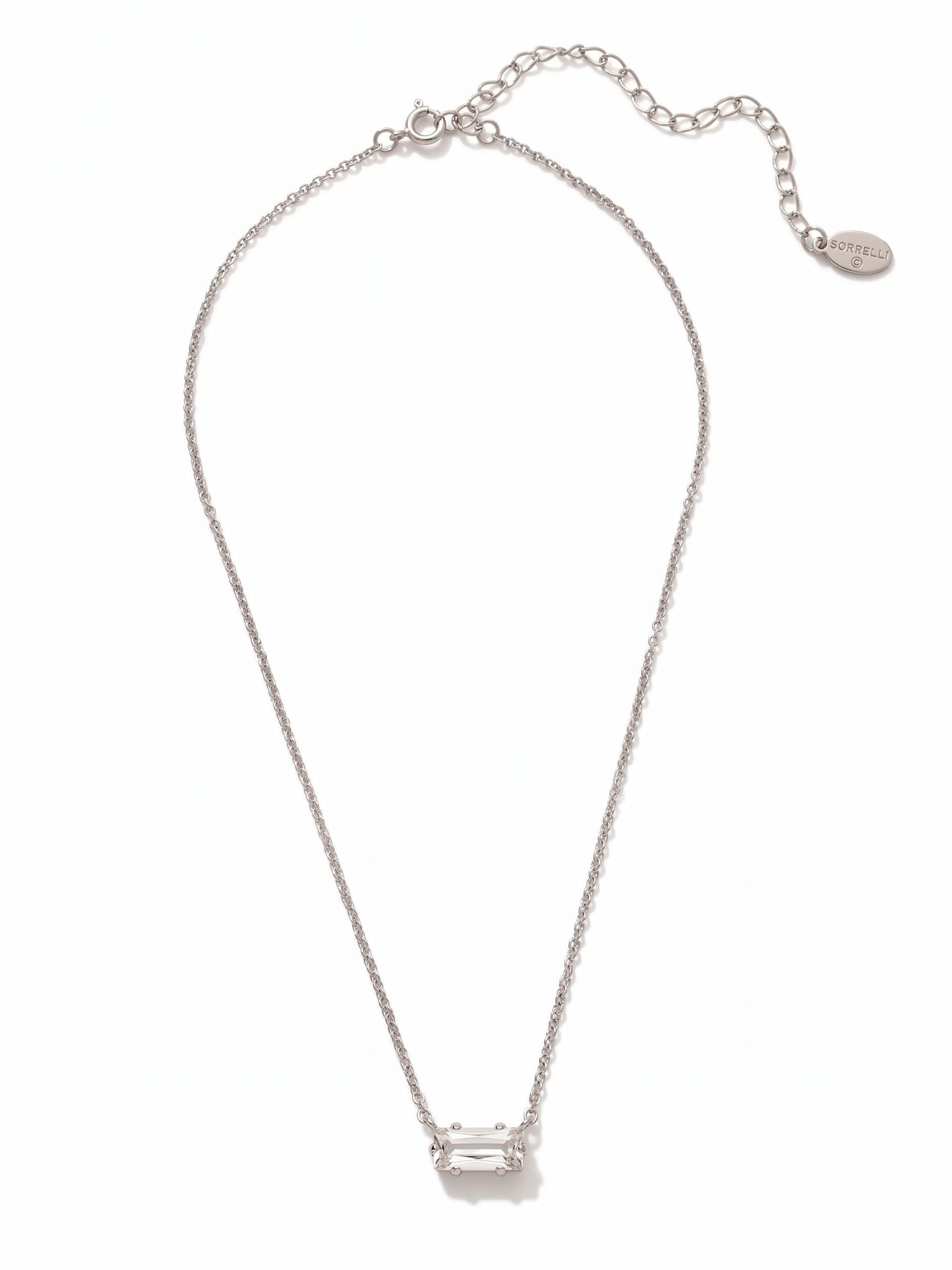 Bindi Pendant Necklace - NFL13PDCRY - <p>A single baguette-cut crystal rests horizontally at the collarbone, suspended on a fine cable chain. The clean lines of the step-cut stone create broad, distinct reflections of light rather than scattered sparkle, giving this necklace a quiet but steady presence. It holds enough visual weight to wear alone with an open neckline, while the slim profile and adjustable length make it an easy base layer to pair with longer strands.</p><ul>
<li>Horizontal baguette-cut crystal creates clean architectural lines</li>
<li>Fine cable chain maintains a lightweight minimalist drape</li>
<li>4-inch adjustable extension chain</li>
<li>Protective e-coat finish for lasting wear</li>
<li>Includes signature organza pouch for gifting and travel</li>
</ul>